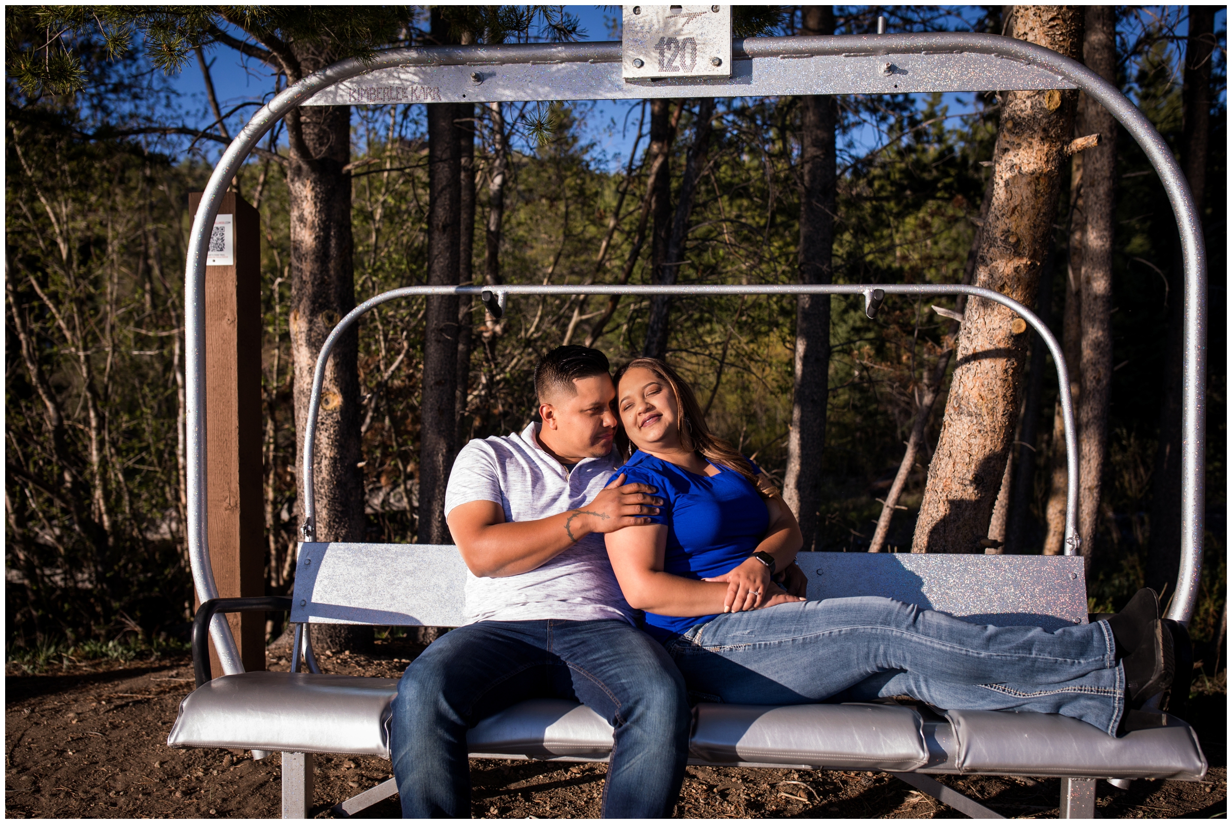 couple posing on chairlift for Colorado engagement portraits 