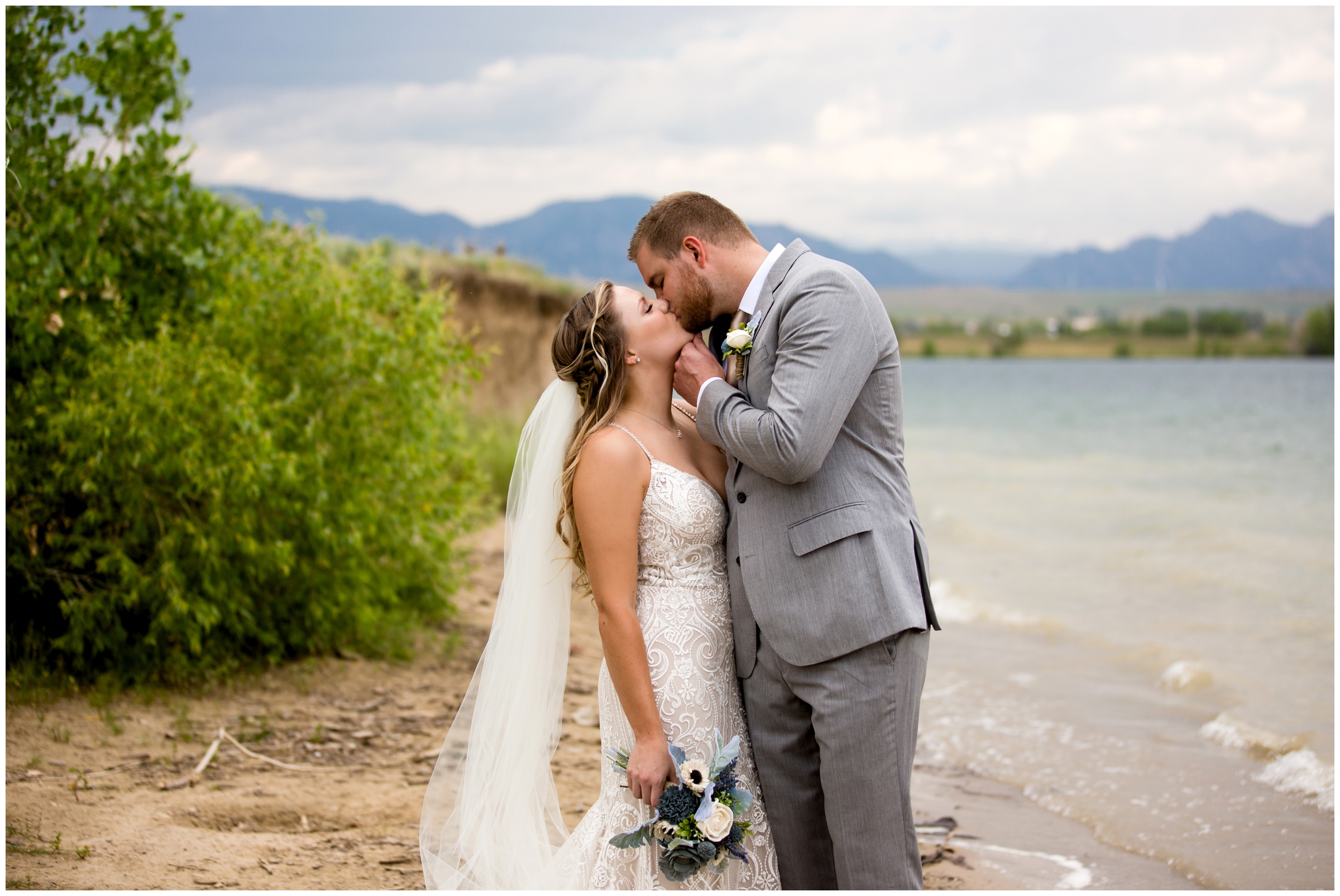 couple kissing in front of lake before their Westminster Colorado wedding at Noah's Event Center 