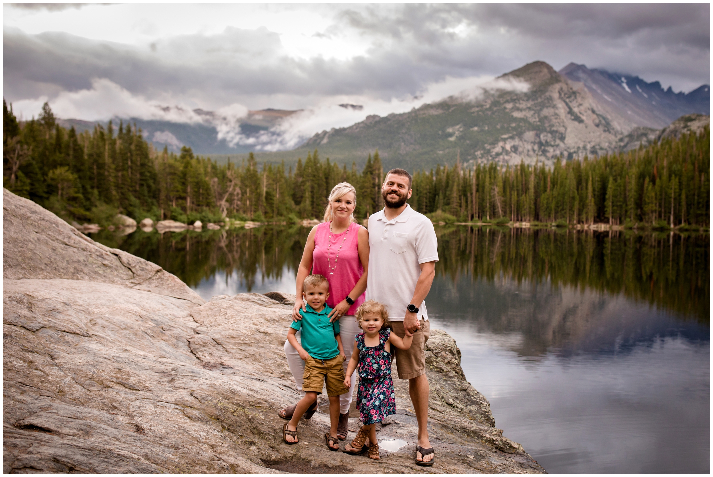 family posing on a rock with Bear Lake in background during Colorado family photos 