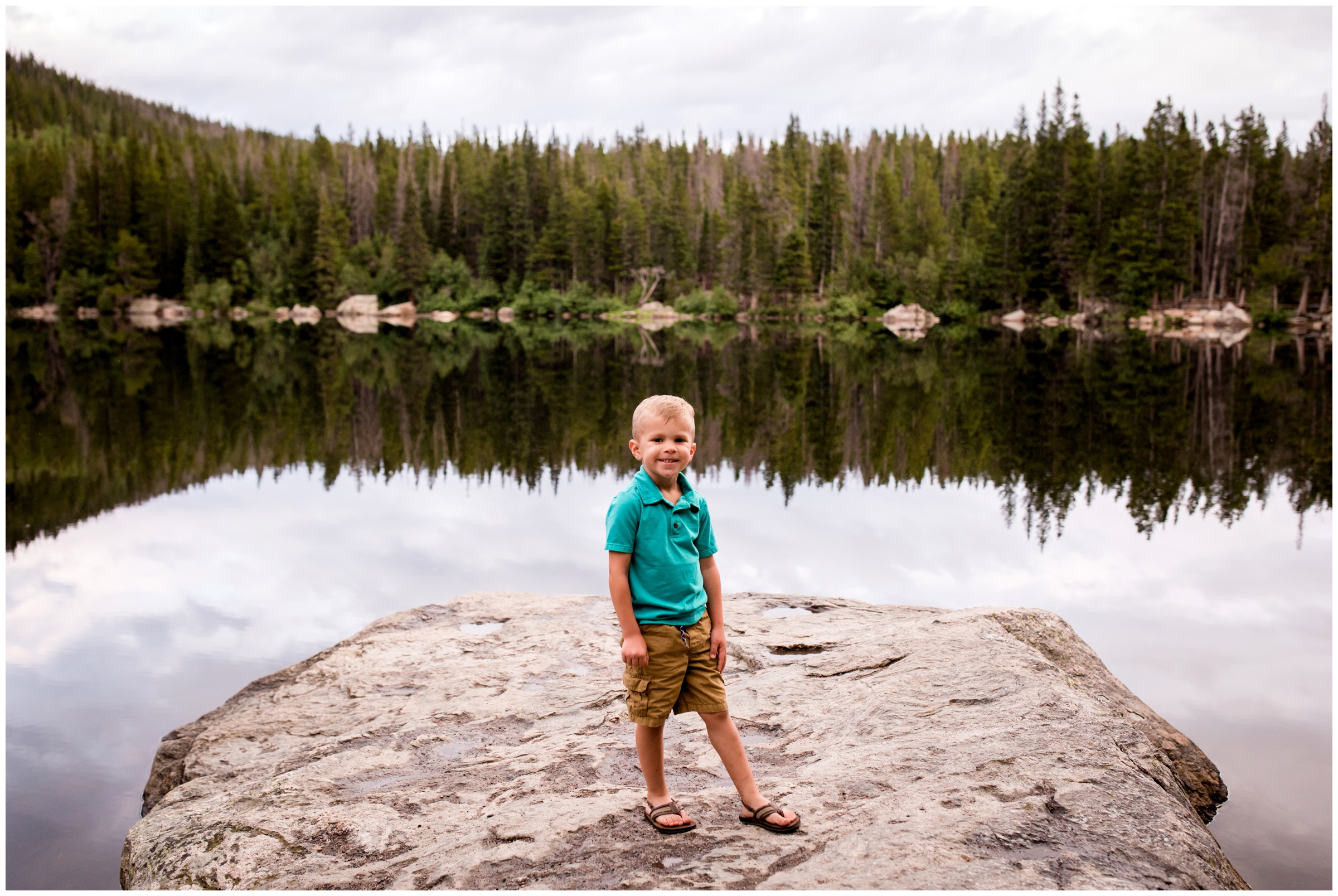 little boy posing on rock during Colorado lake family photography session 