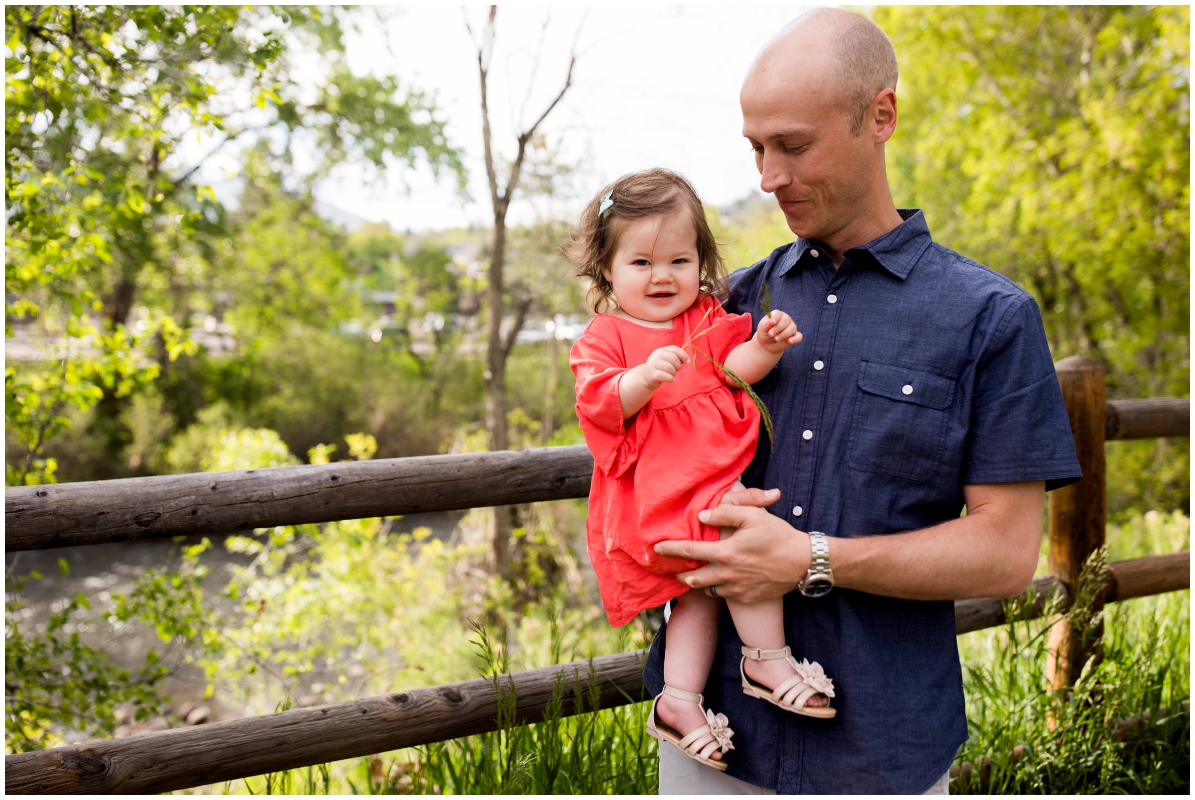 dad holding baby daughter during Colorado childrens photography session
