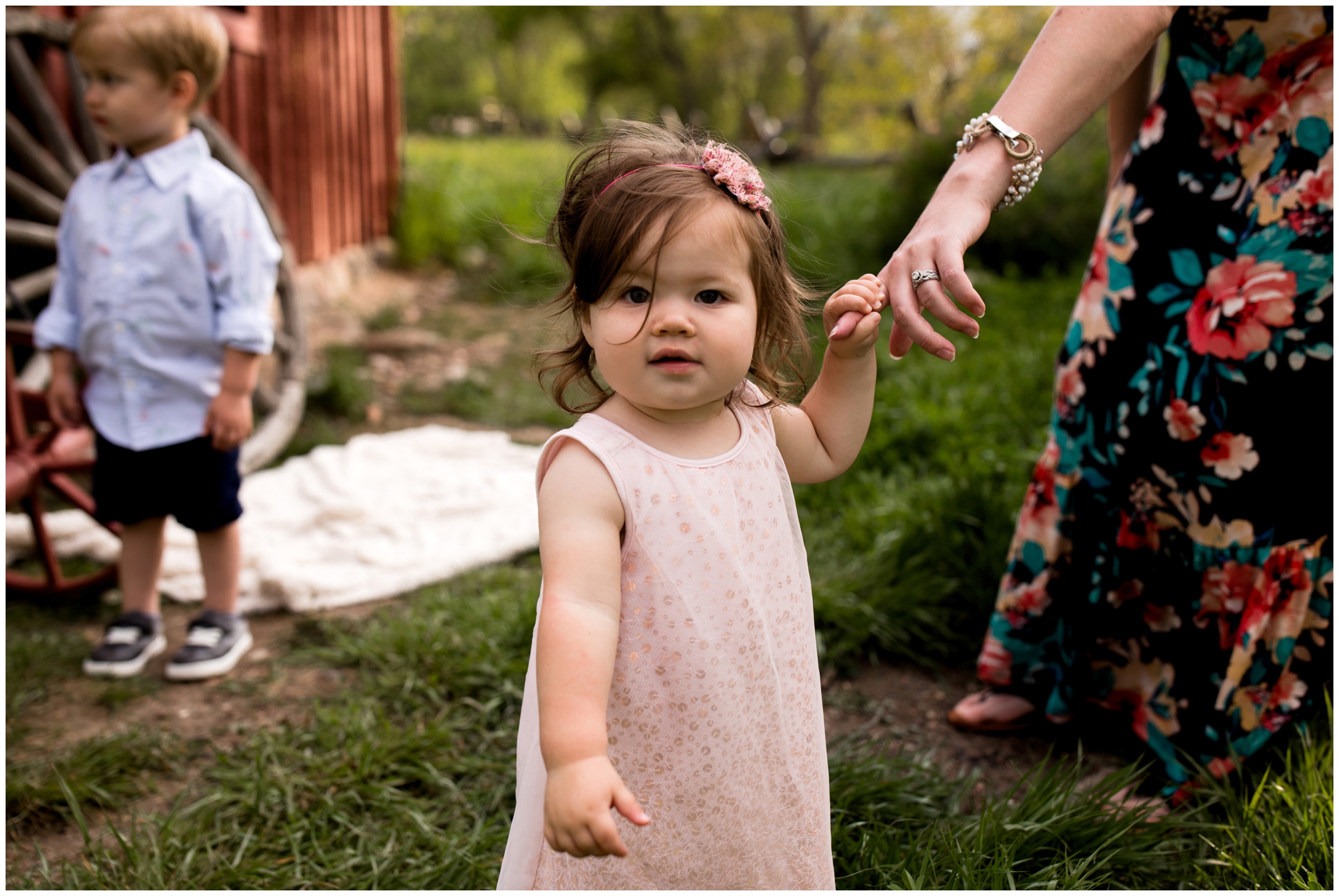 daughter holding mother's hand during Colorado children's portraits 