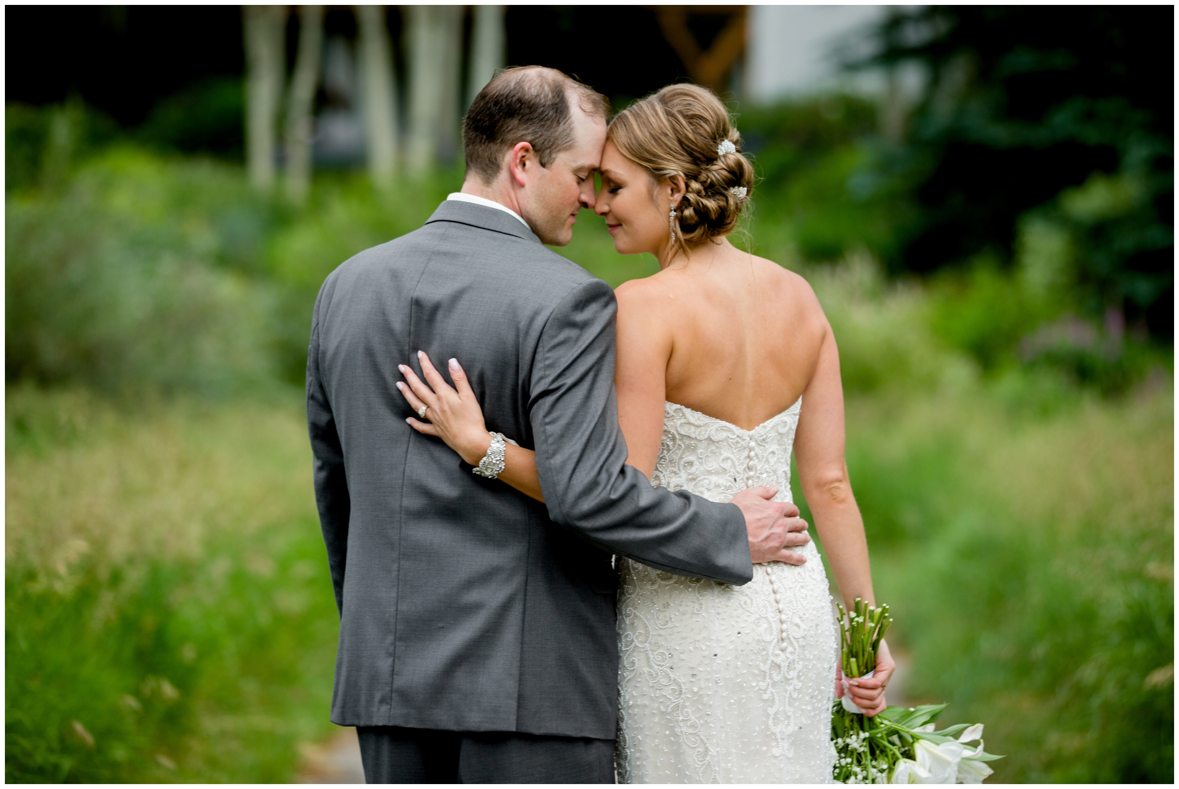 Couple embracing after their Vail Golf Club wedding island ceremony 