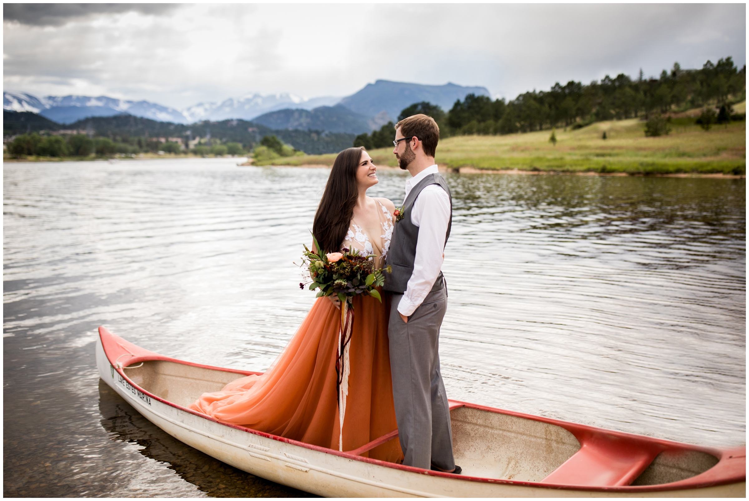 couple posing in a canoe during Estes Park Colorado elopement photos 