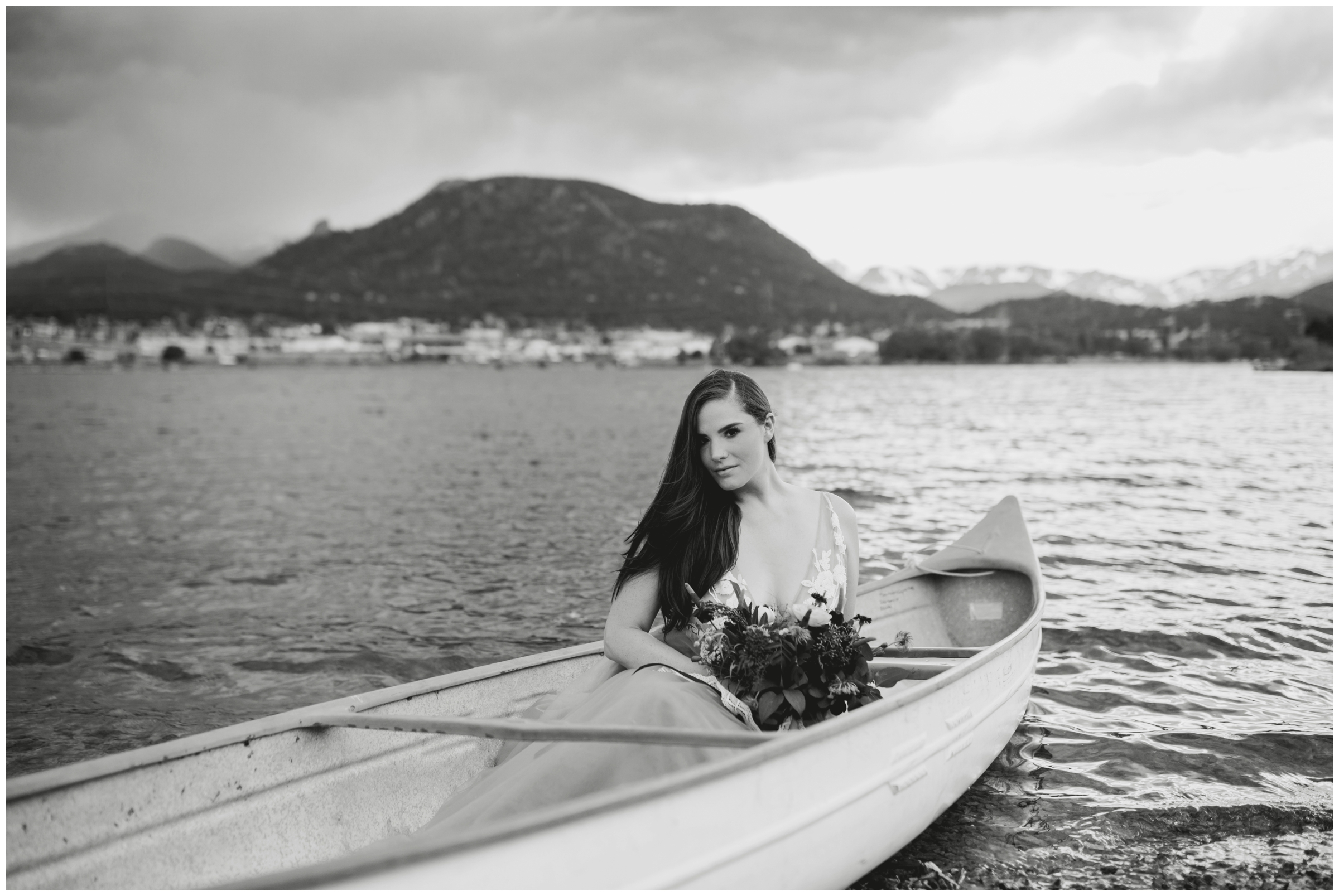 Colorado bride posing in a canoe with mountains in background 