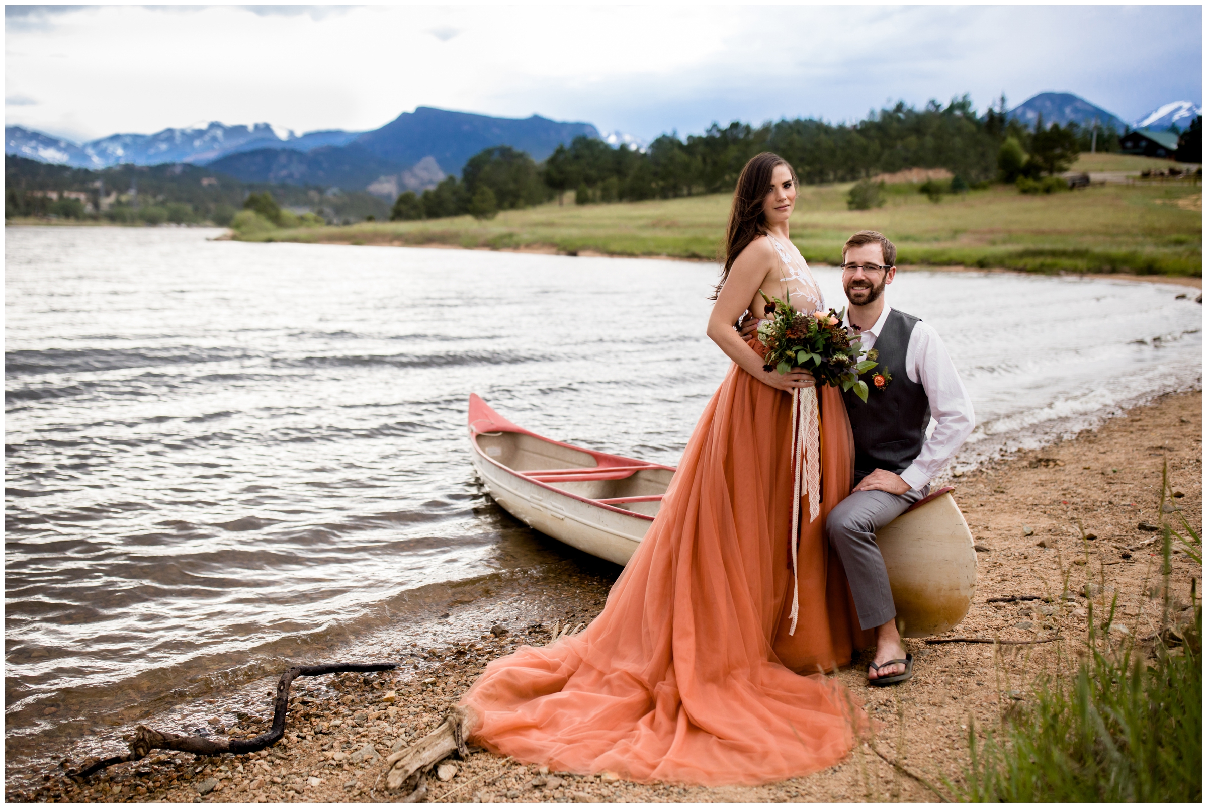 couple posing with a canoe during Colorado lake wedding in Estes Park 