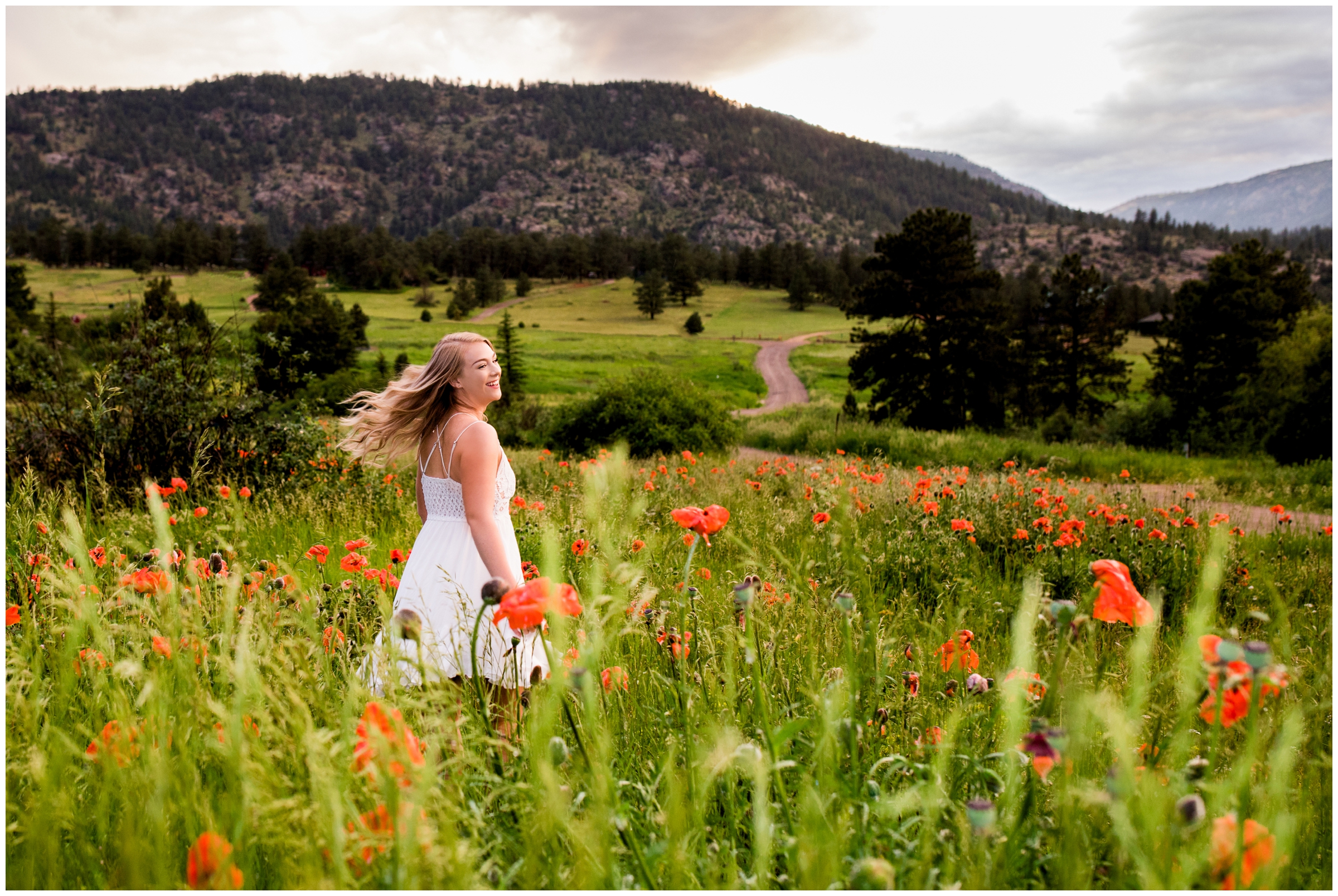 teen girl in white dress twirling during Colorado mountain senior photography session 