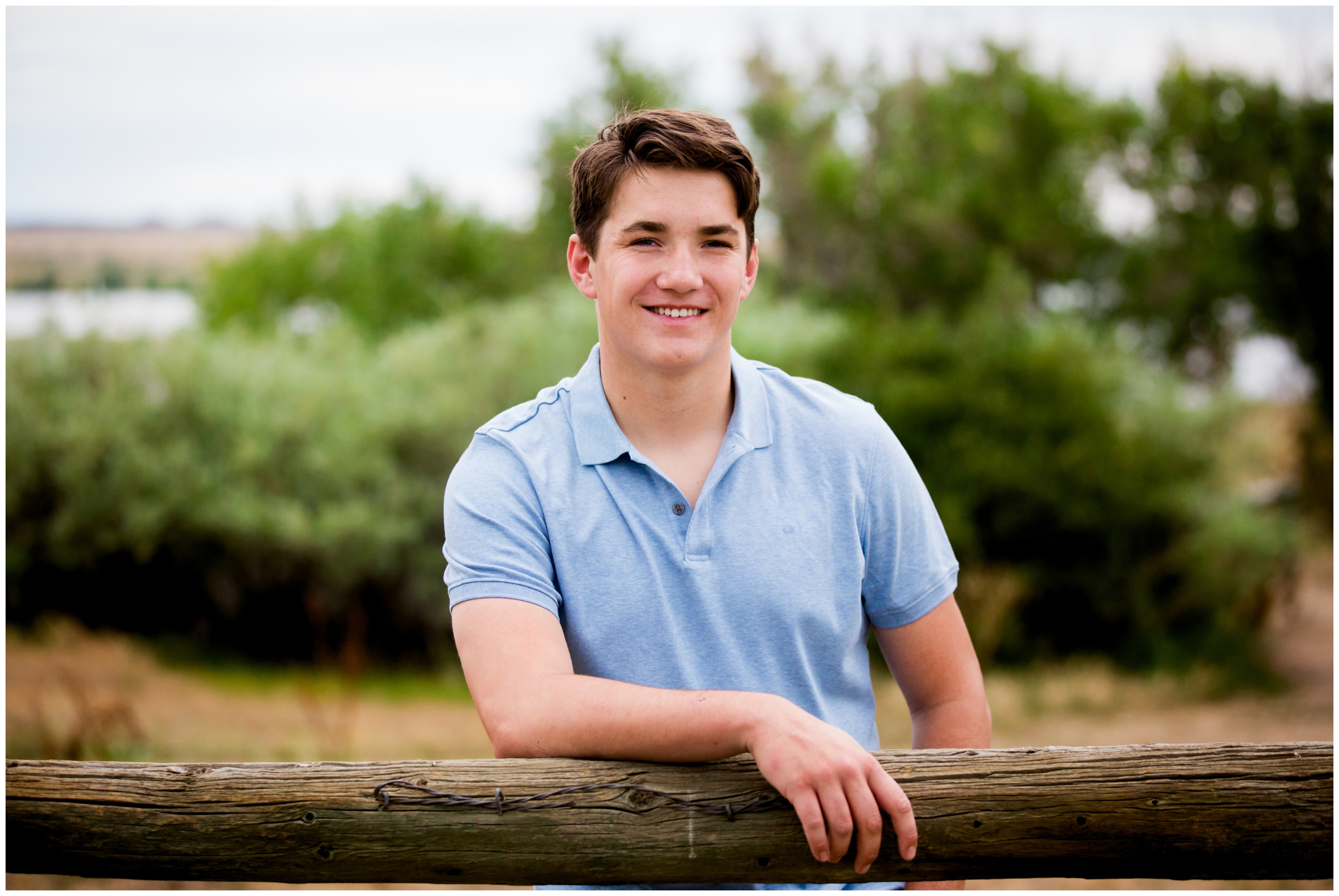 teen leaning against fence during Monarch High School senior pictures 