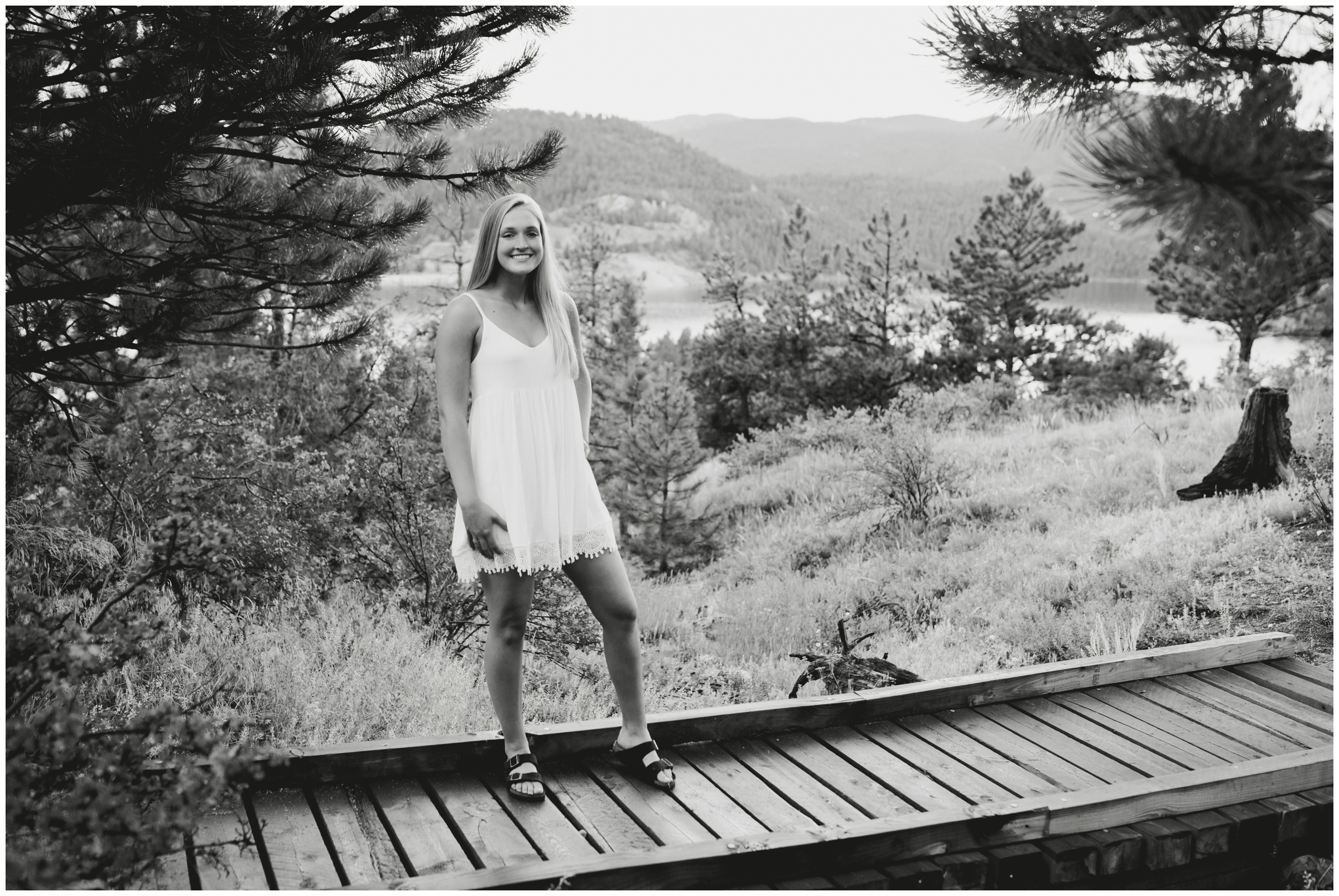 teen girl posing on wooden bridge during Colorado senior pictures 
