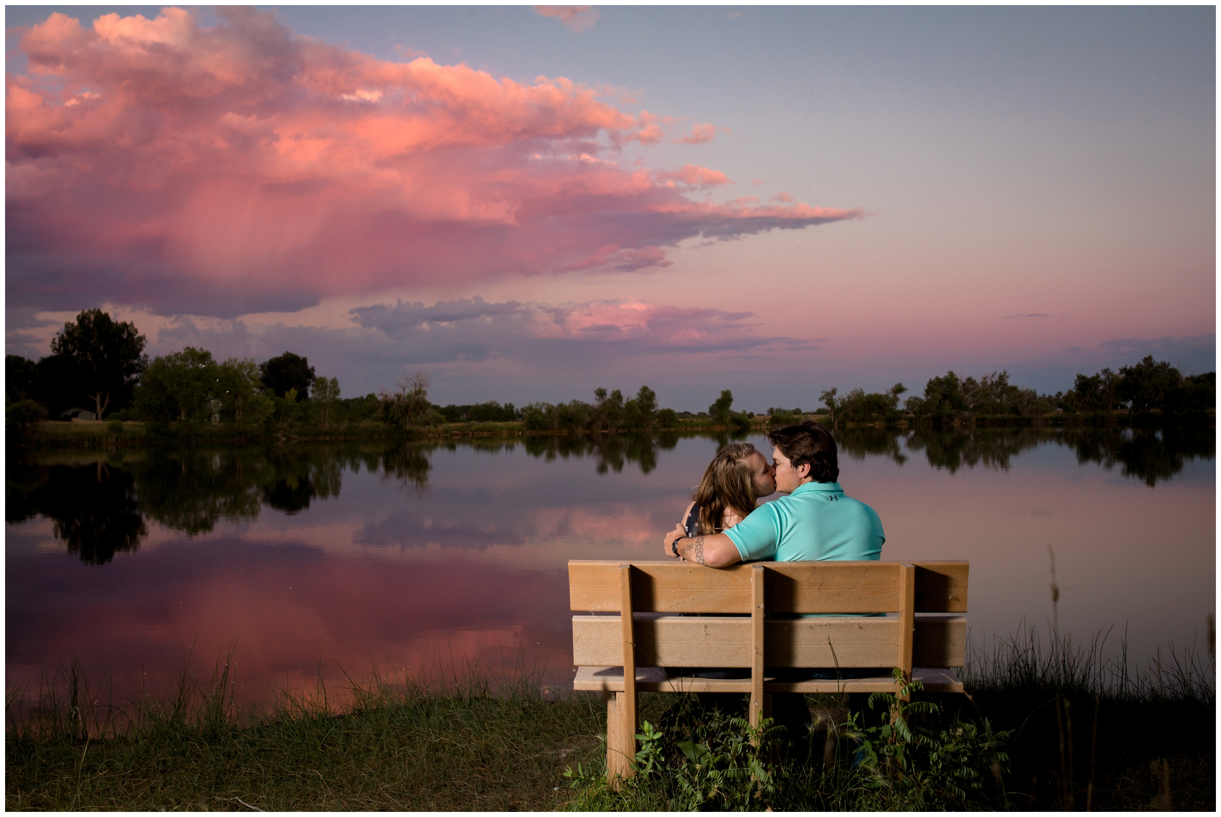 couple kissing on bench at Riverbend Ponds at sunset 