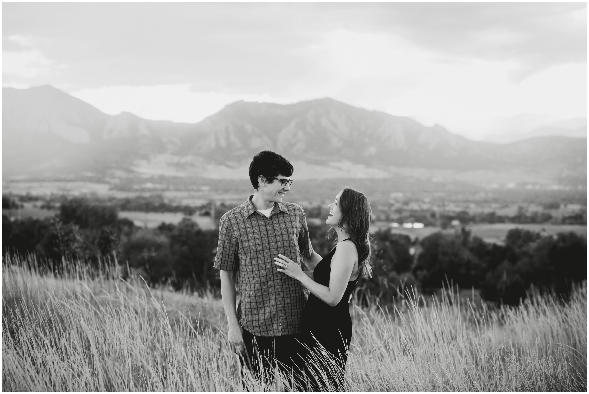 photo laughing with mountains in background during Boulder engagement portraits at Davidson Mesa