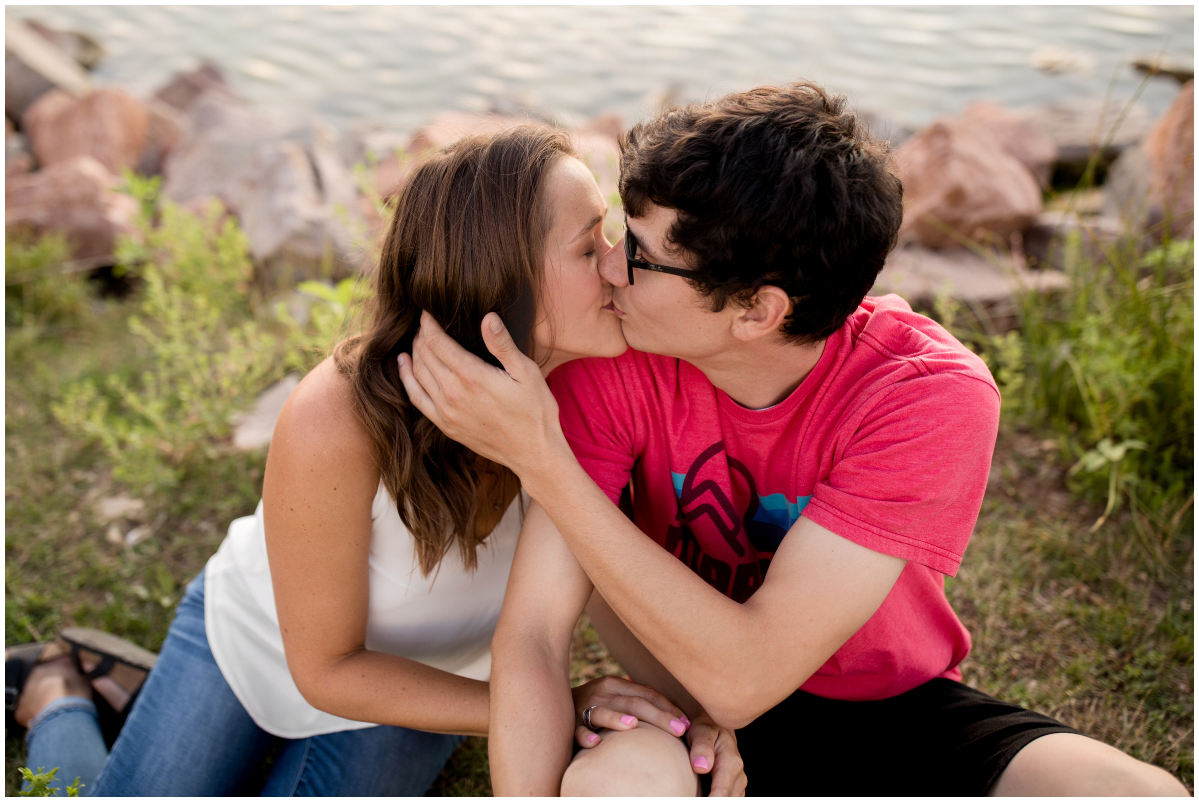 couple kissing next to a lake in Louisville Colorado 