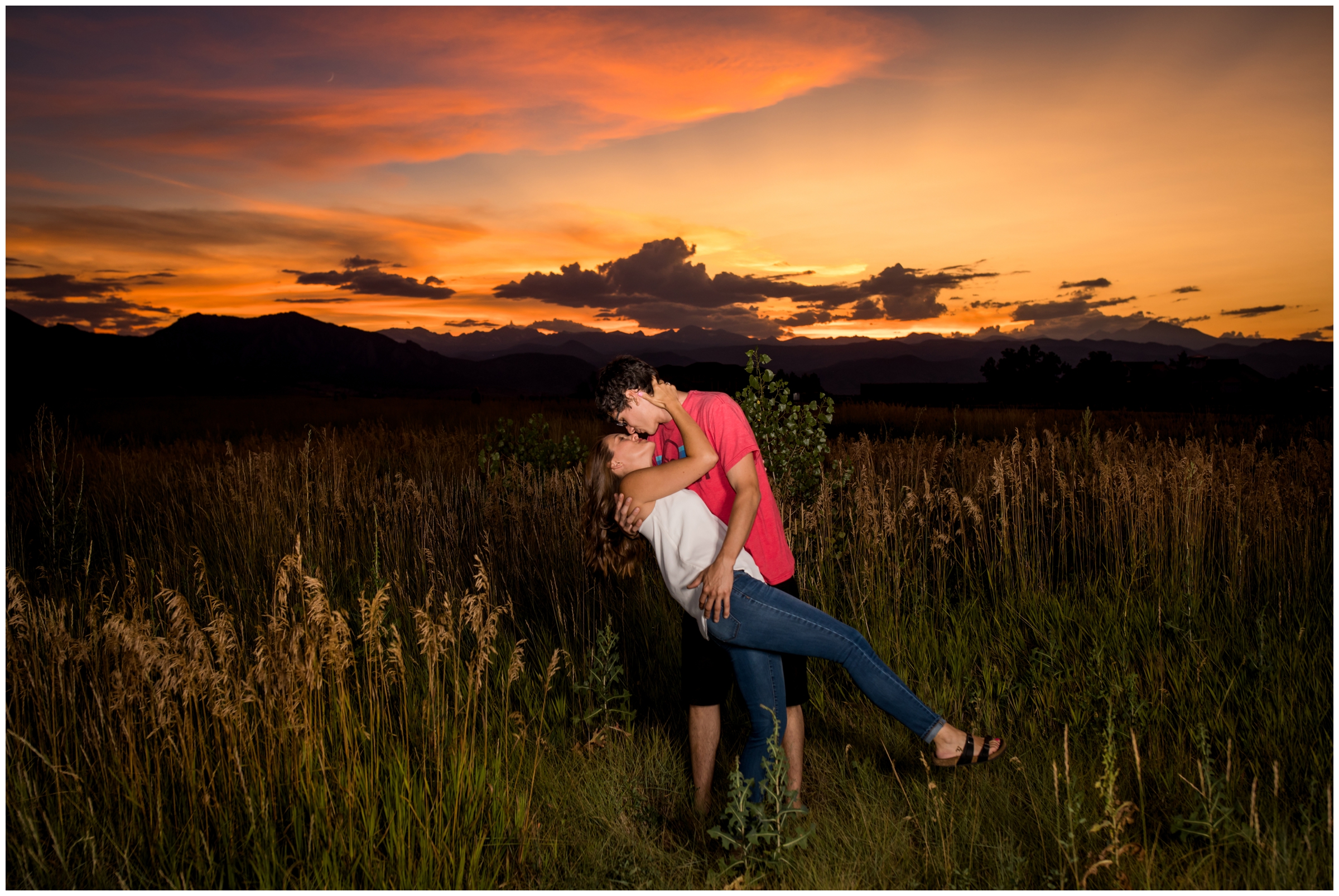 couple kissing in front of amazing sunset during Boulder engagement portraits by Plum Pretty Photo 