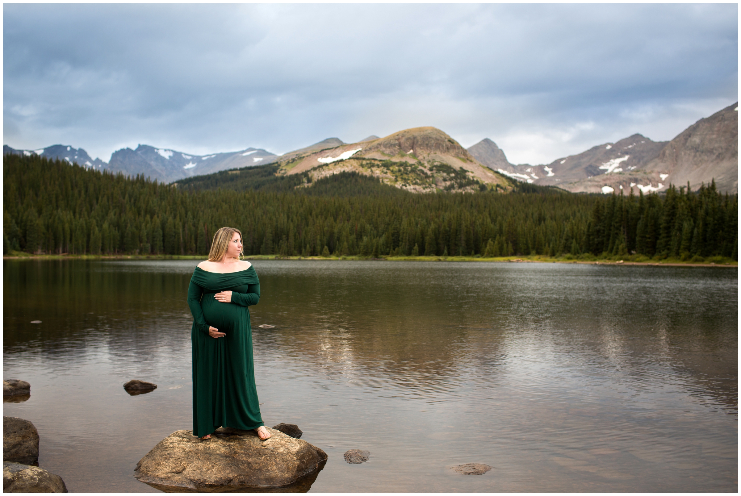 pregnant woman posing on a rock during Colorado lake pregnancy portraits 
