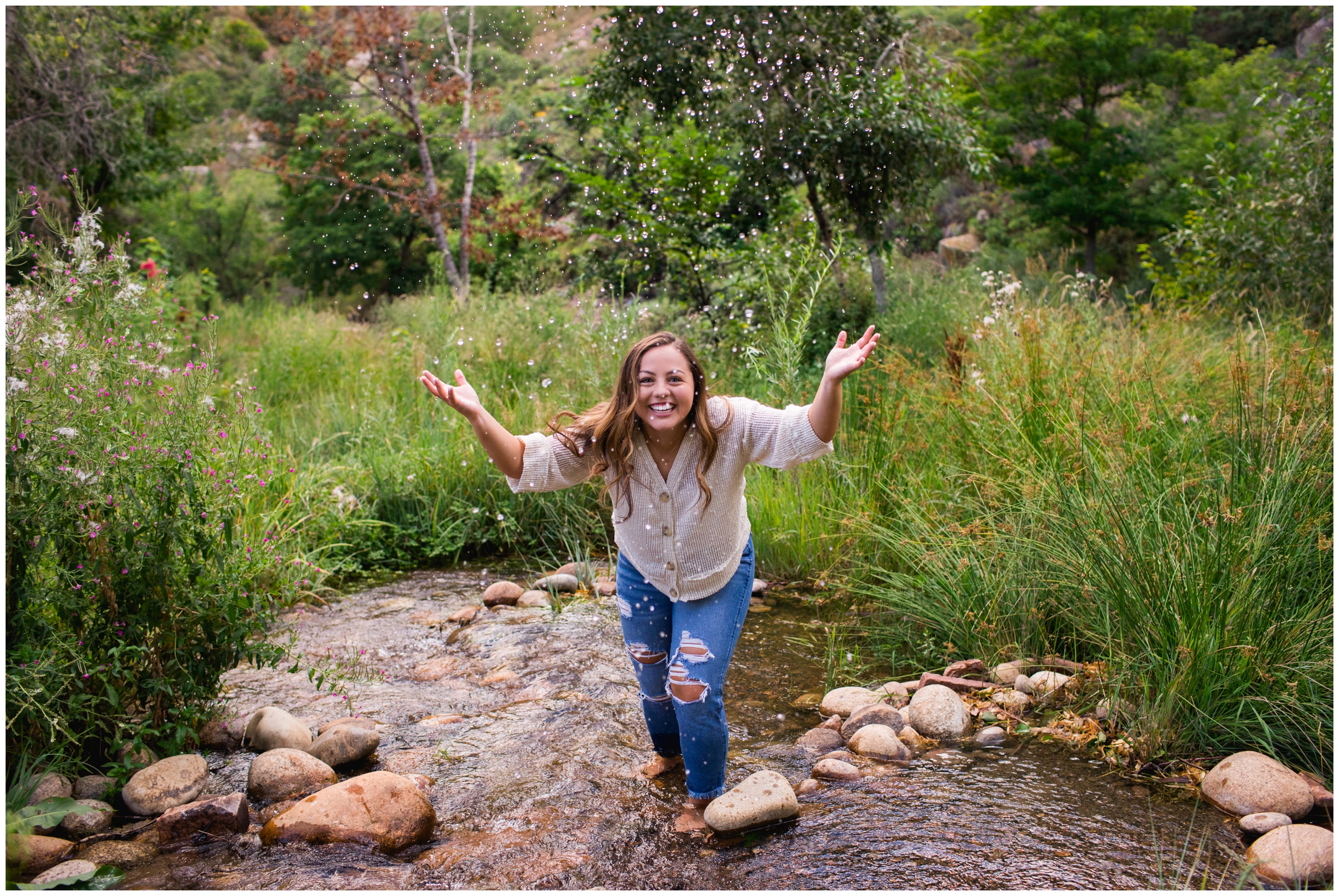 teen splashing in river during Colorado mountain senior photos 
