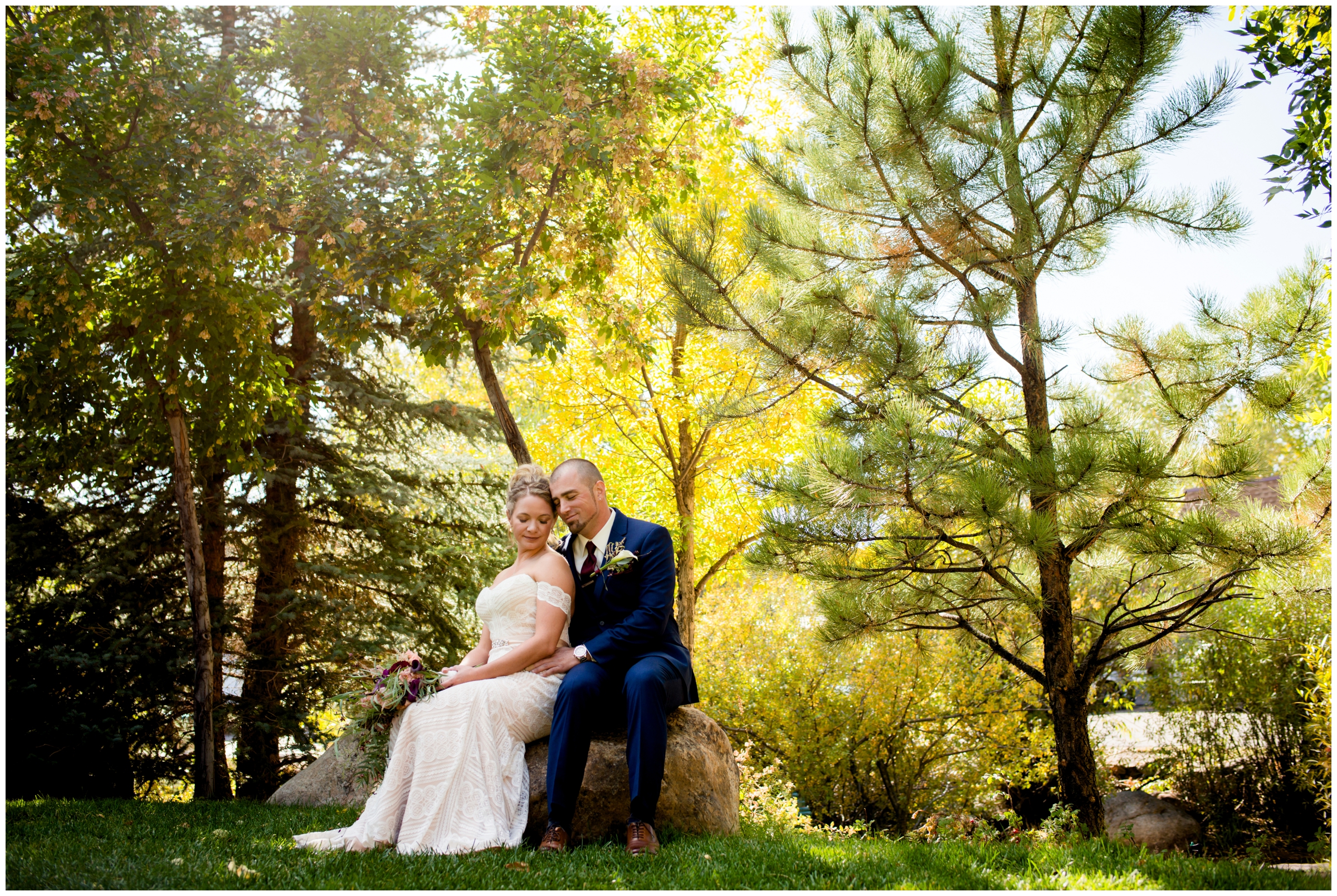 bride and groom sitting on a rock at Skyview Fall River Village Estes Park wedding 