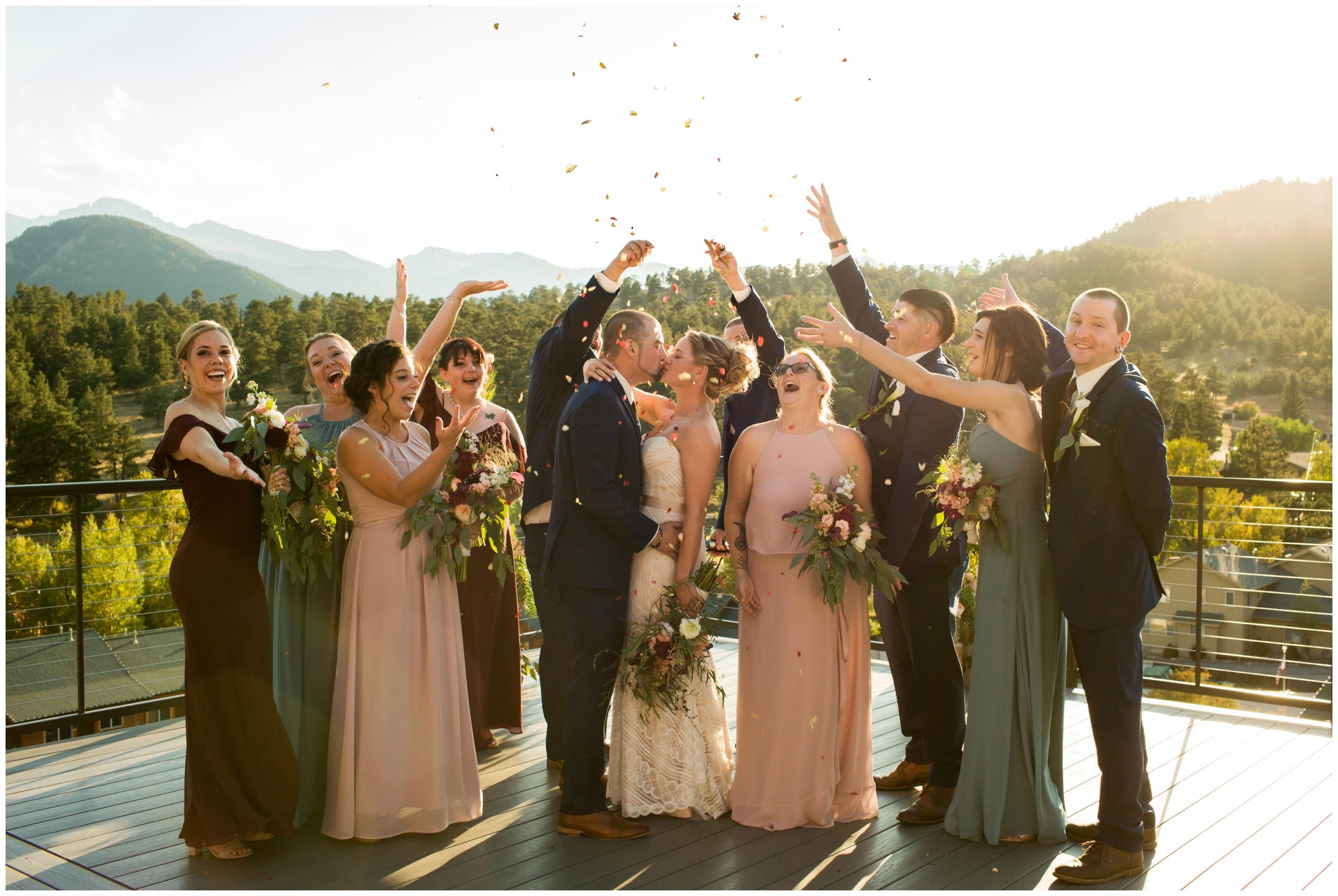 bridal party throwing rose petals on bride and groom at Skyview Fall River wedding Estes Park 