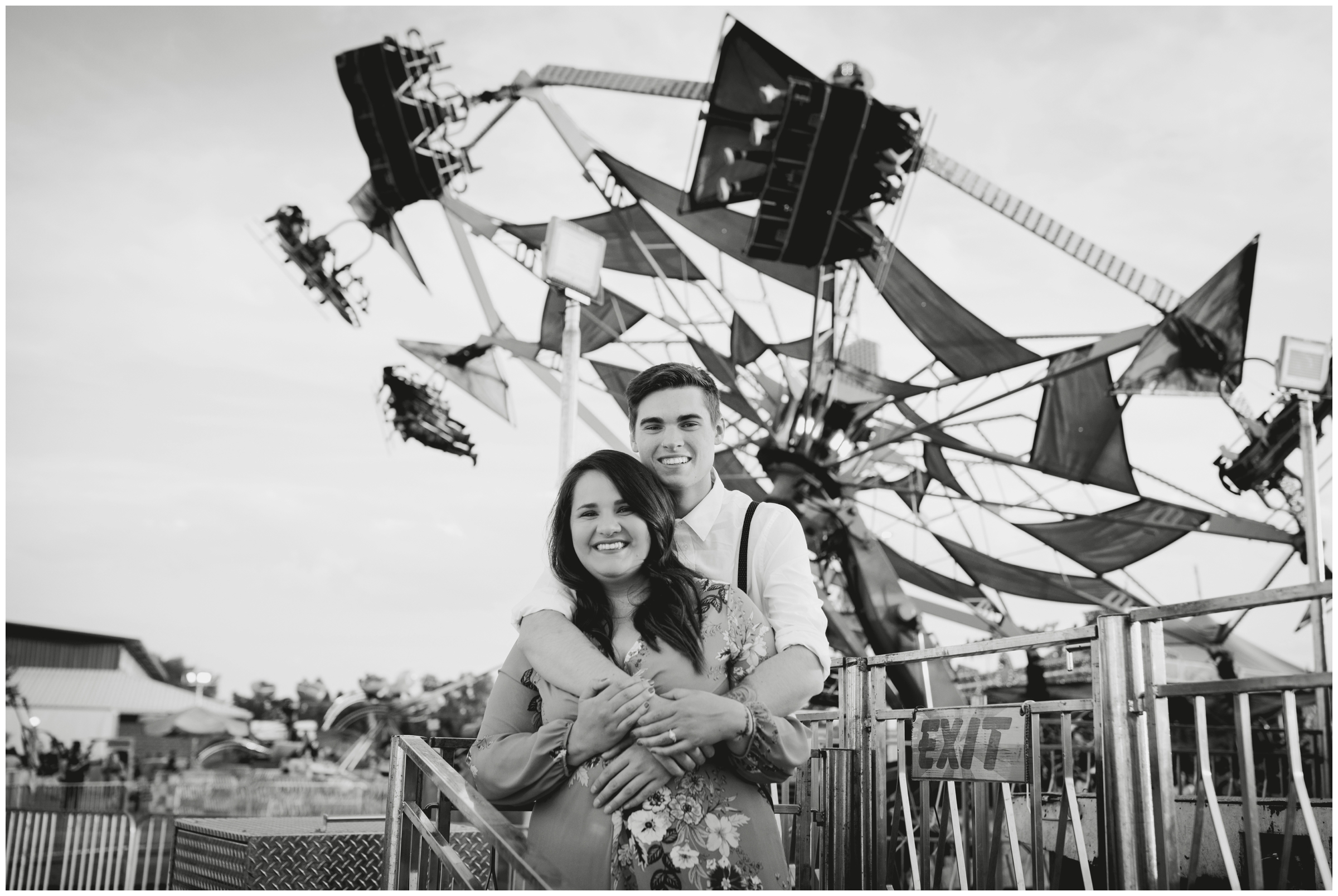 couple posing in front of amusement ride at fair engagement photography session in Colorado 