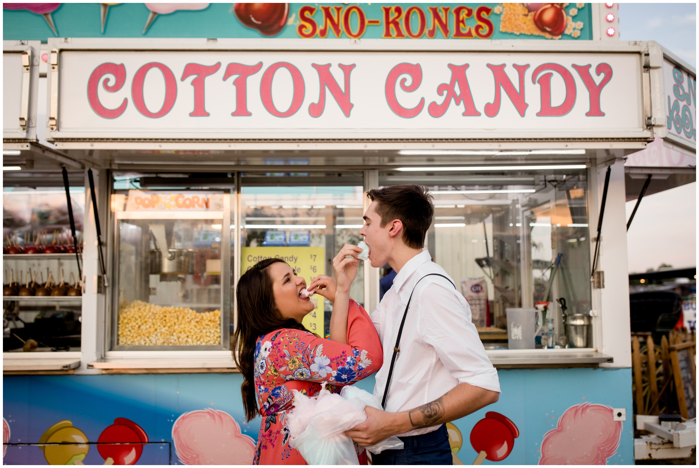 couple feeding each other cotton candy during Longmont Colorado fair engagement photos