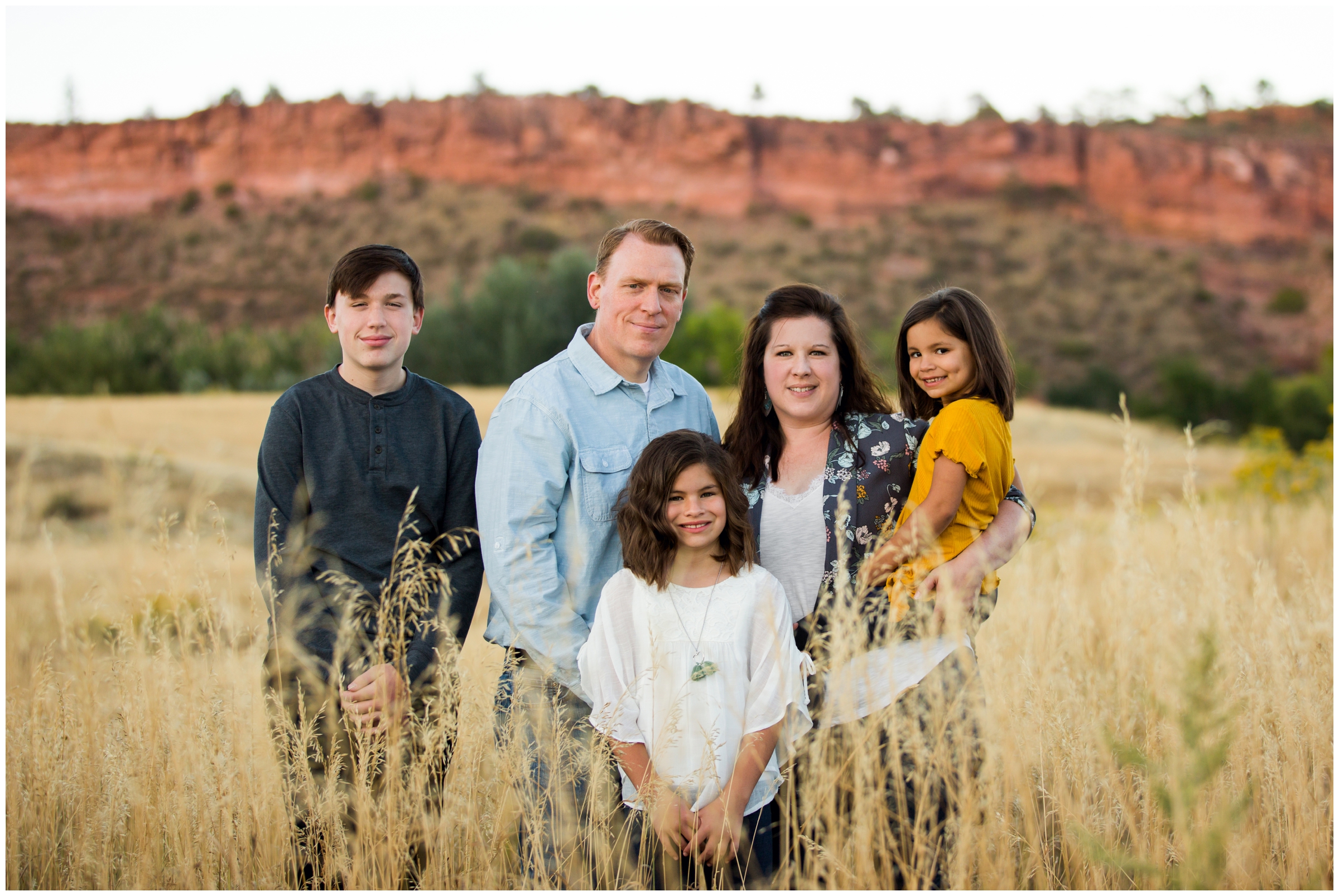 family posing in field during their Fort Collins family photography session 