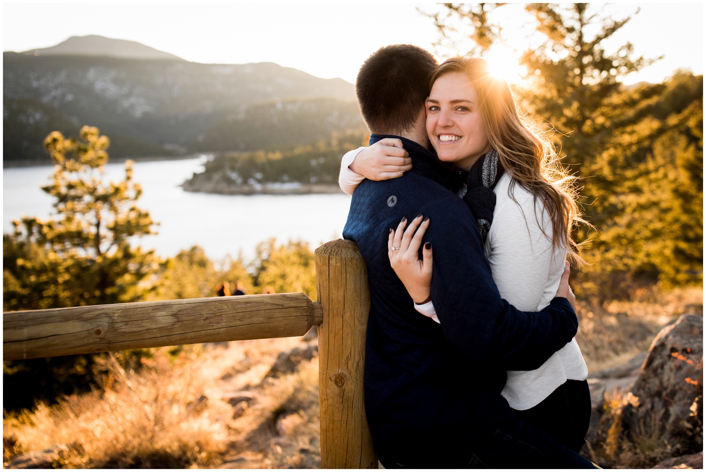 couple hugging with mountains in background at Gross Reservoir Colorado engagement photos 