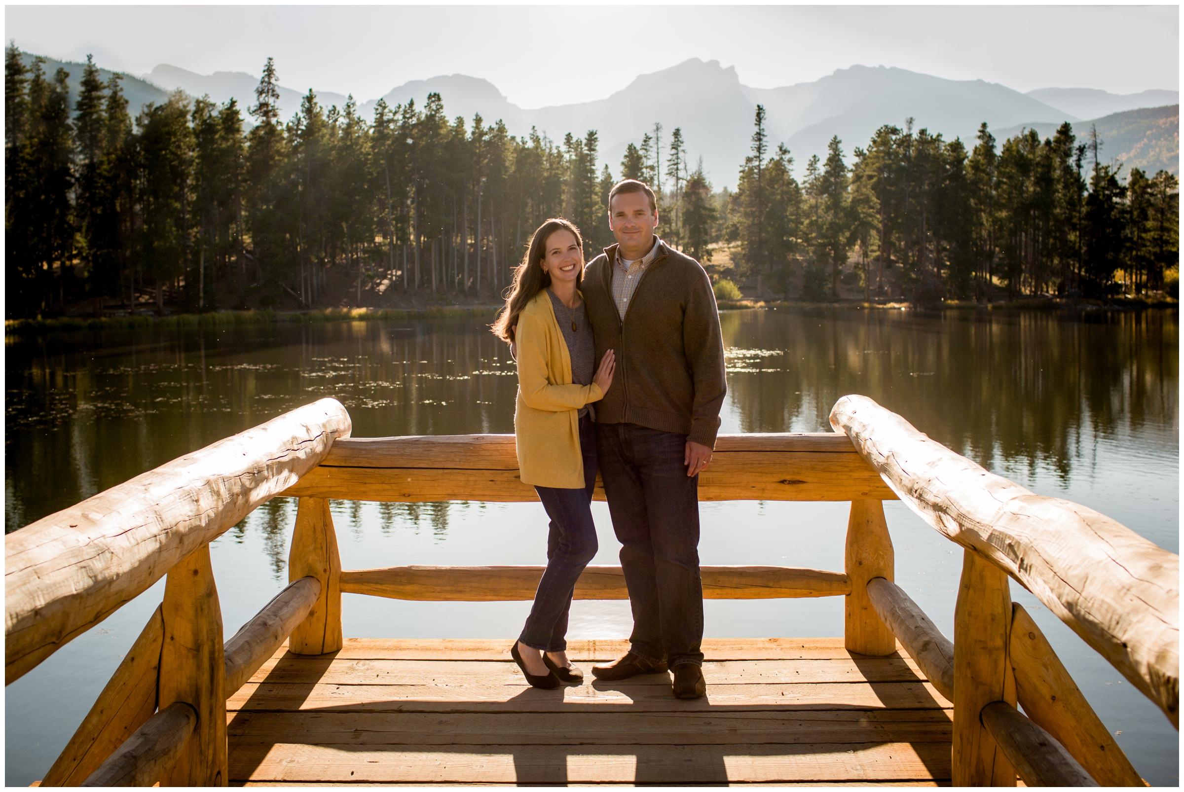 couple posing on dock at Sprague Lake during Estes Park photo shoot 