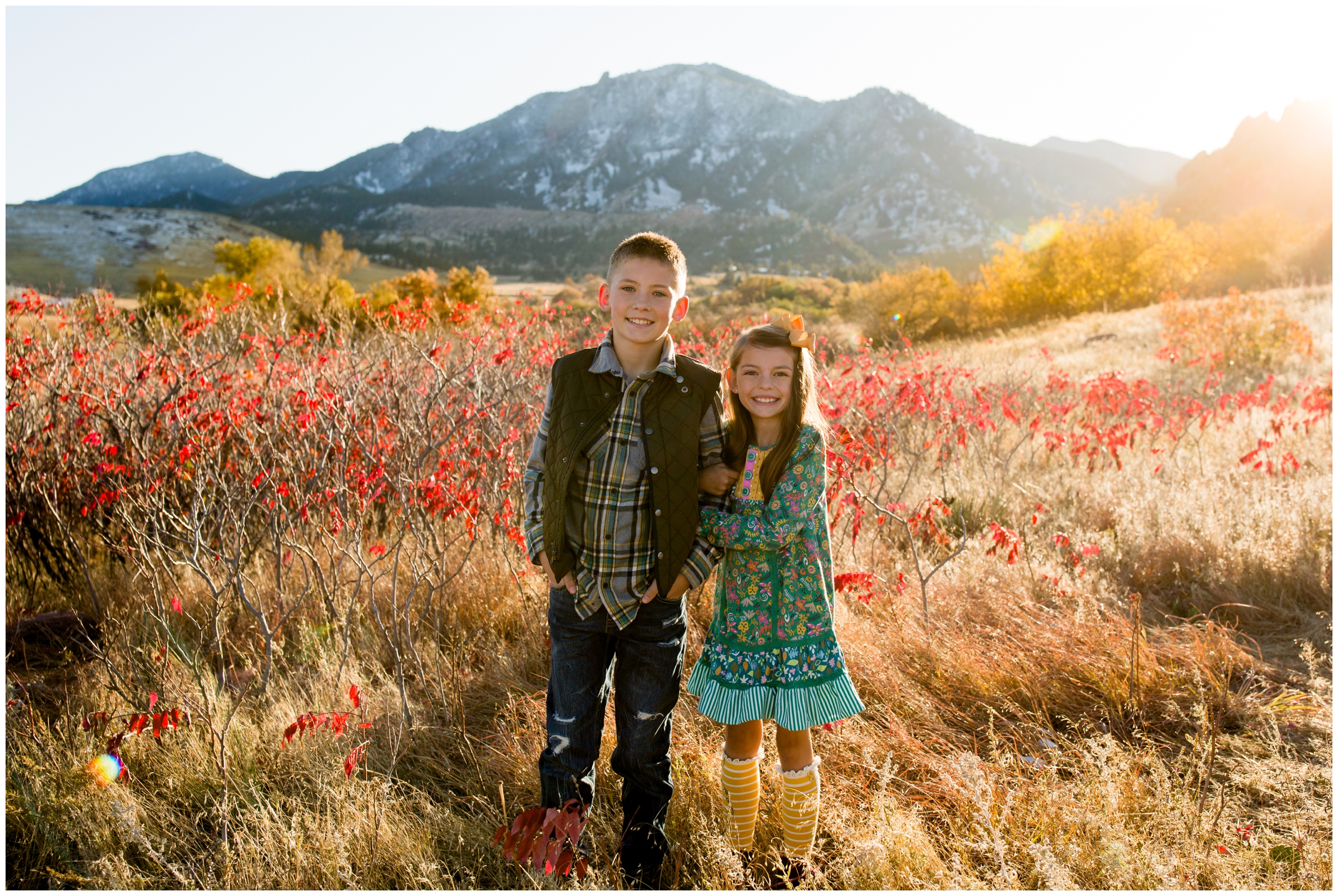 kids posing with flatirons in the background during Boulder fall family photography session 