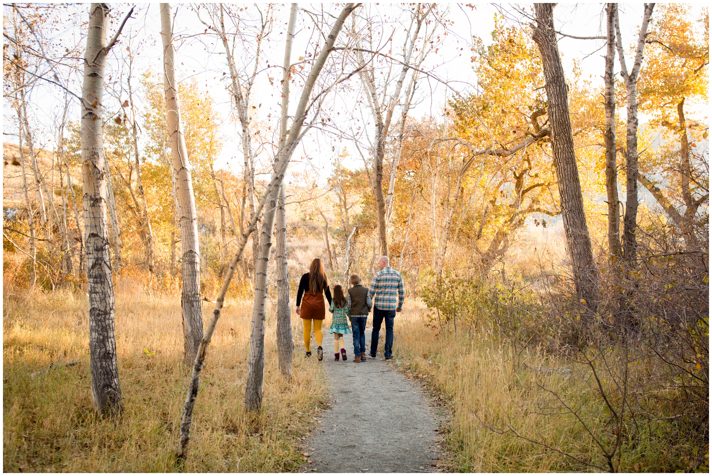 family holding hands and walking during candid Colorado family pictures 
