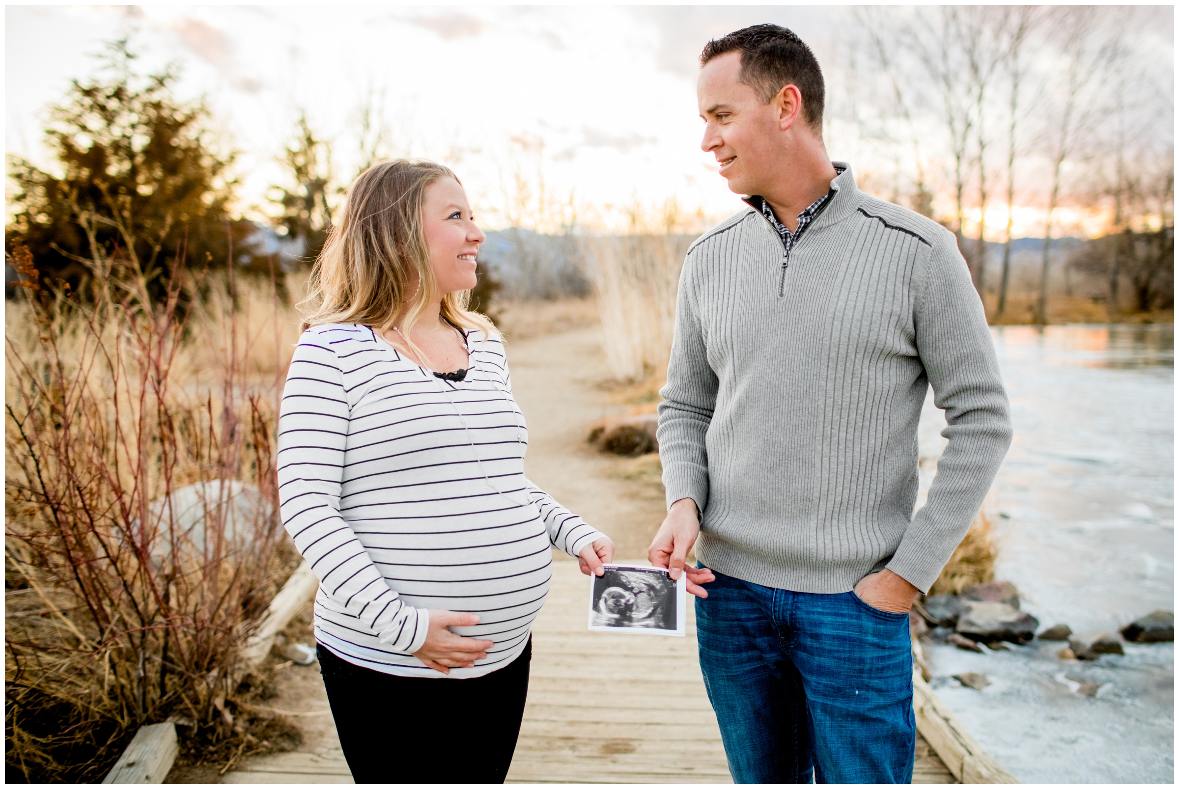 couple holding ultrasound photo during Colorado maternity pictures at Coot Lake Boulder 