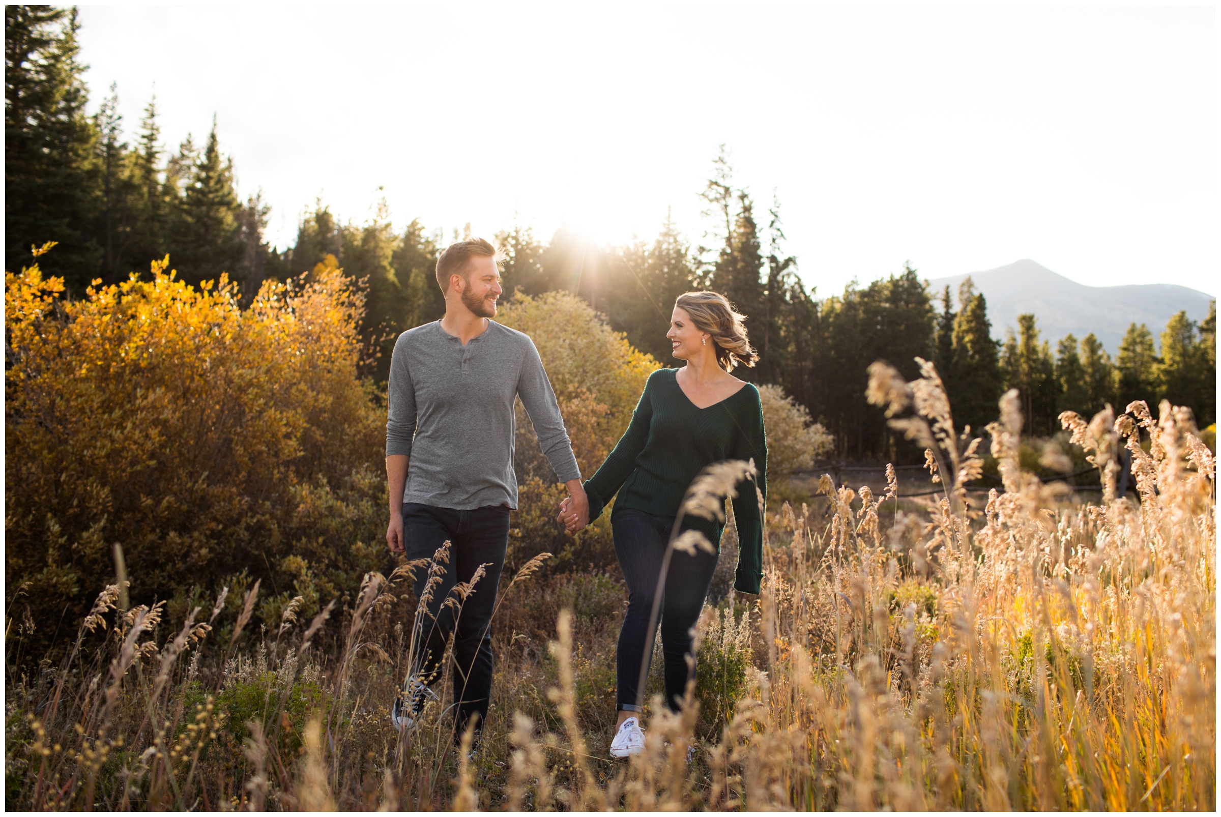 couple walking through open field during Breckenridge Colorado mountain engagement photos 