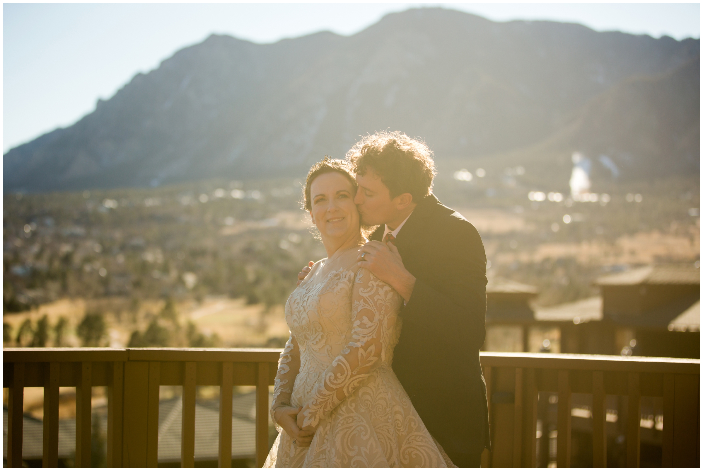 couple kissing during their sunny Colorado springs wedding portraits 