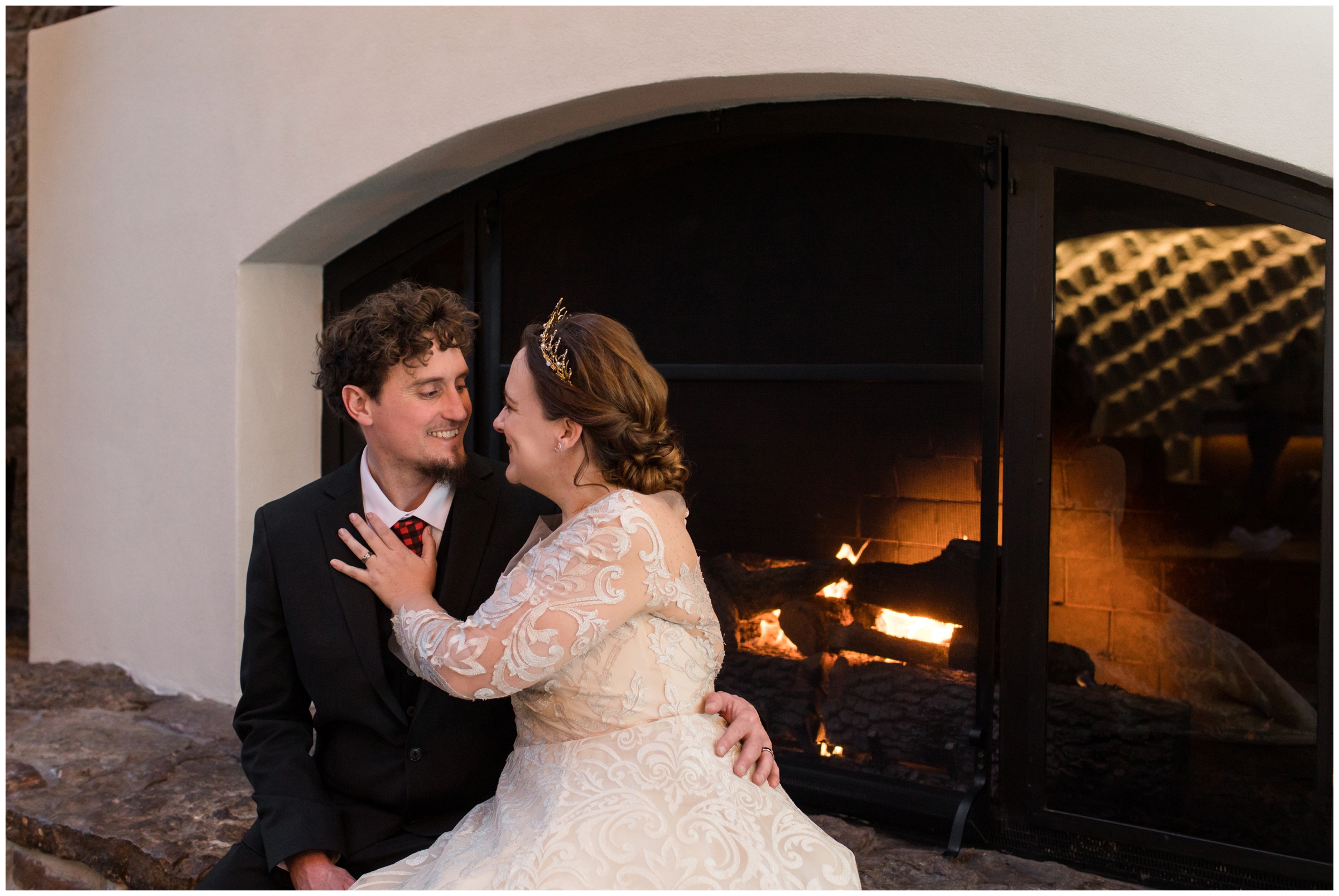 couple cuddling by fireplace during Cheyenne Mountain Resort Colorado winter wedding 