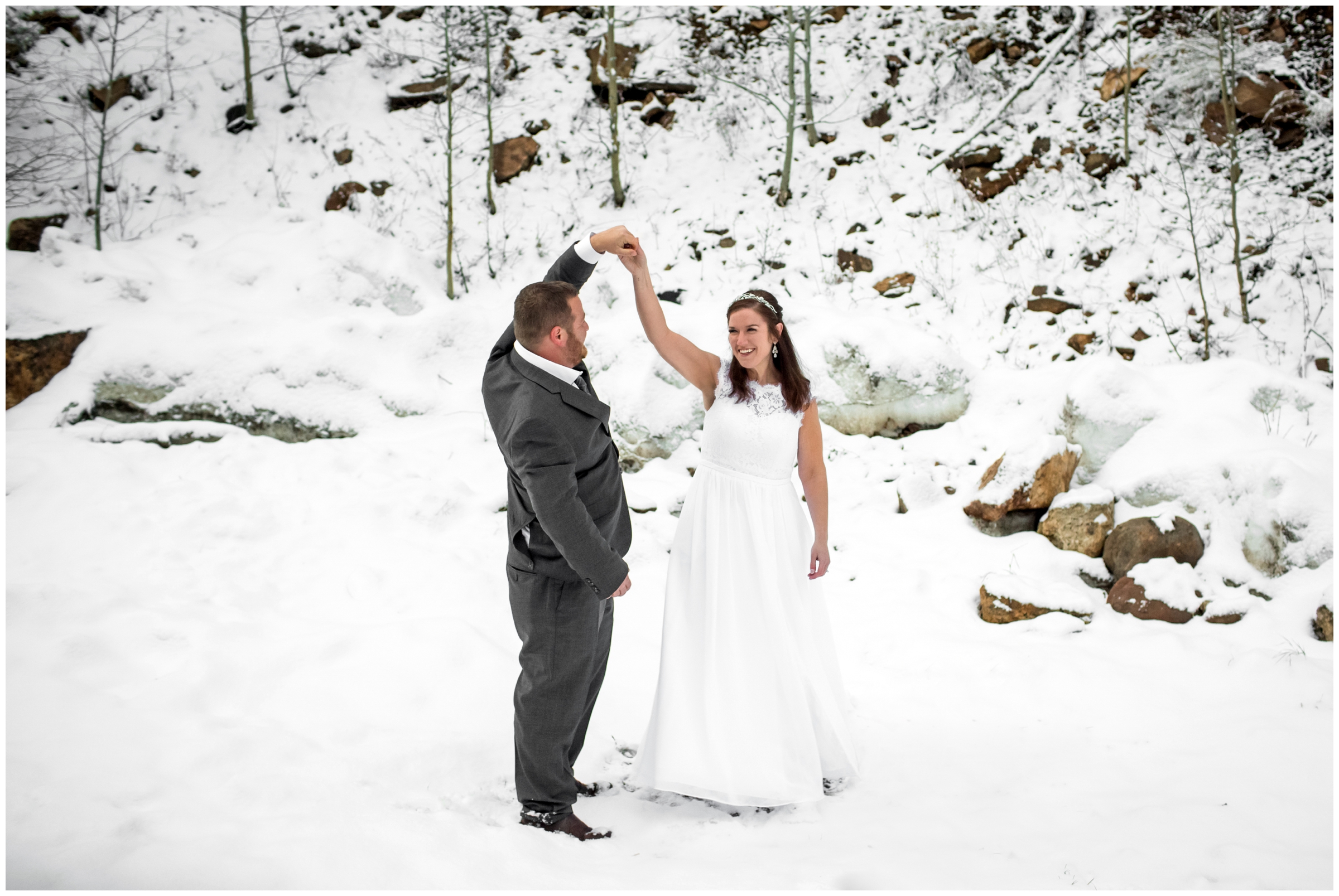 groom spinning bride during snowy Colorado winter wedding