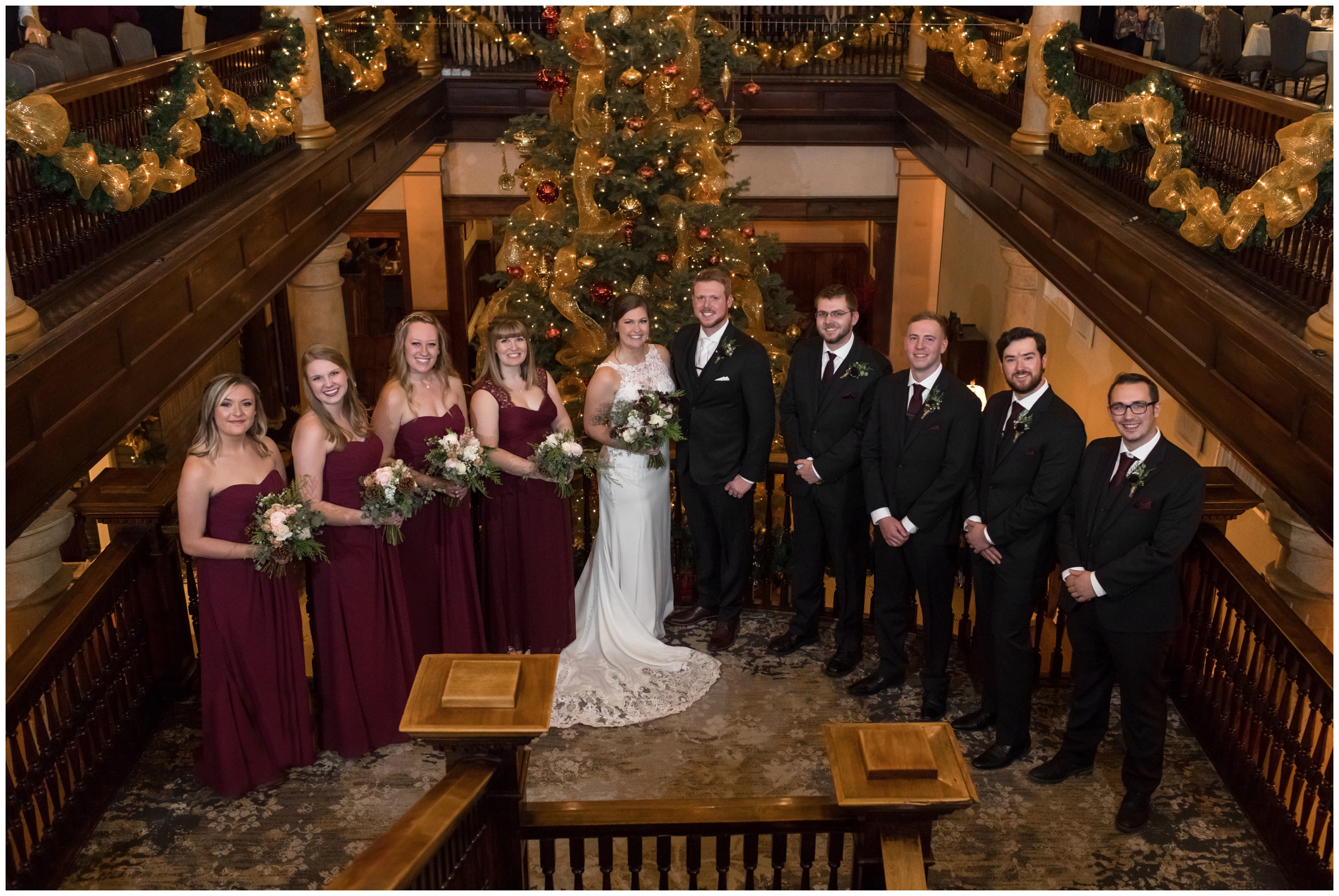 bridal party posing on staircase at Hotel Boulderado during Colorado winter wedding photos 
