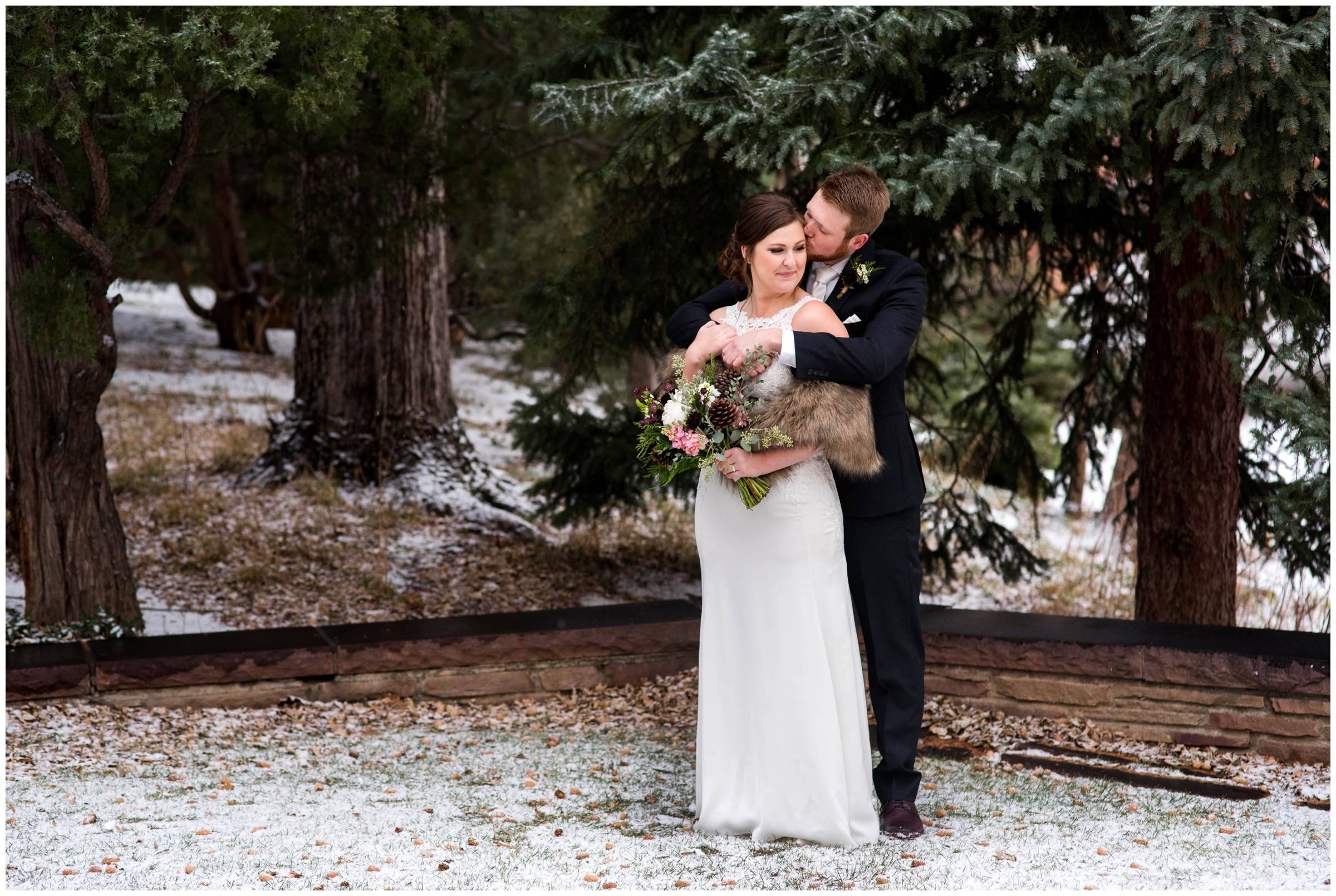 couple snuggling in snow during Colorado winter wedding photos 