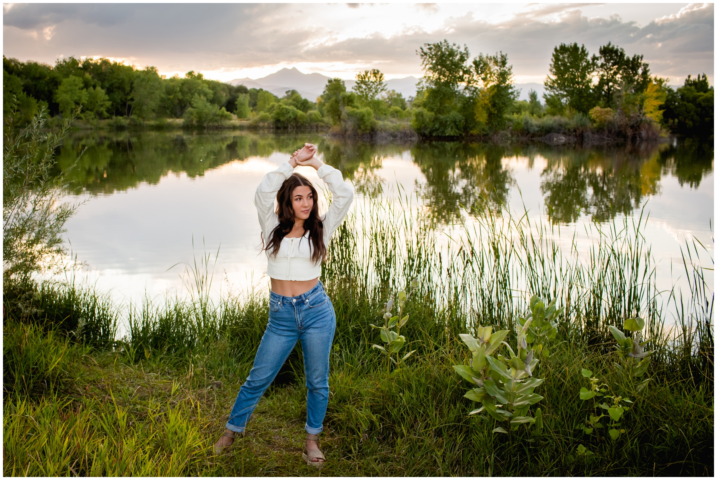 teen dancer posing with lake behind her during Erie High senior photography session 