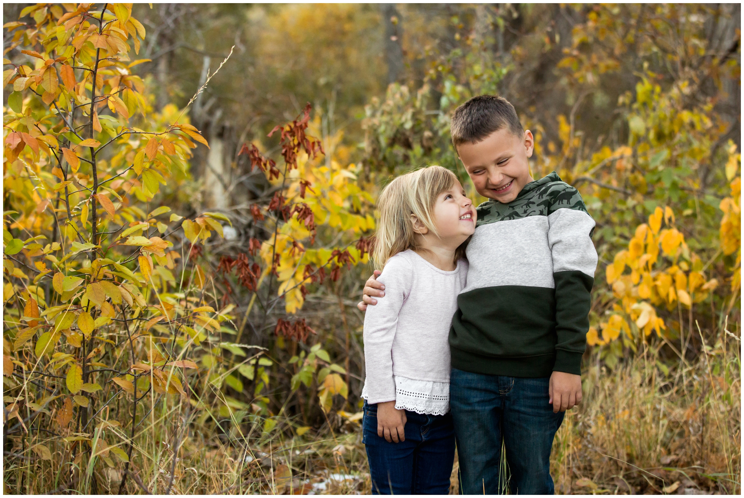 siblings laughing during Colorado fall family photography session 