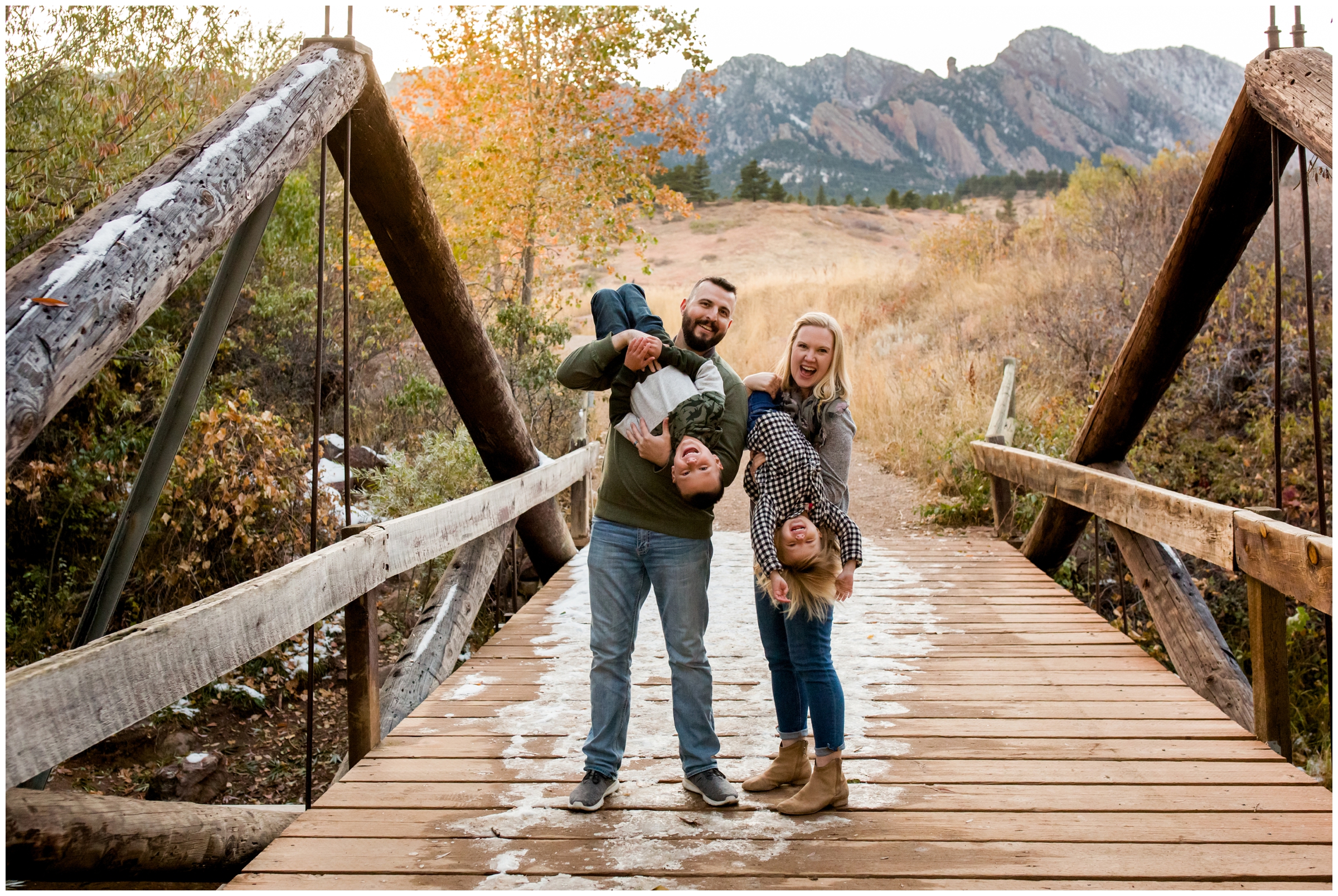 family posing on wooden bridge during Colorado fall family portraits 
