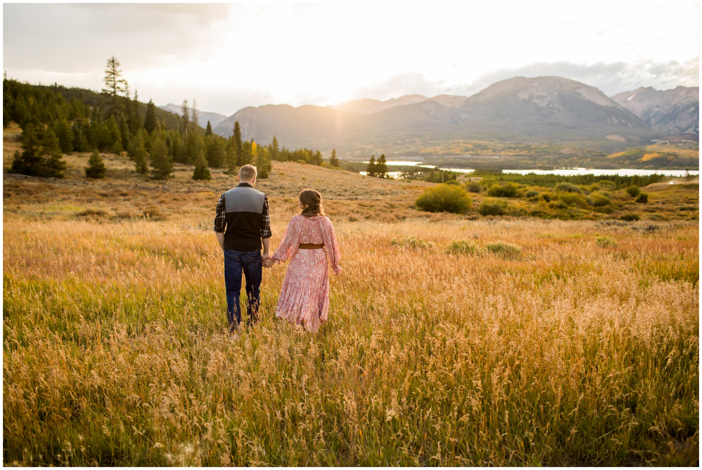 couple walking through field at Windy Point Campground during Dillon Colorado engagement photos 
