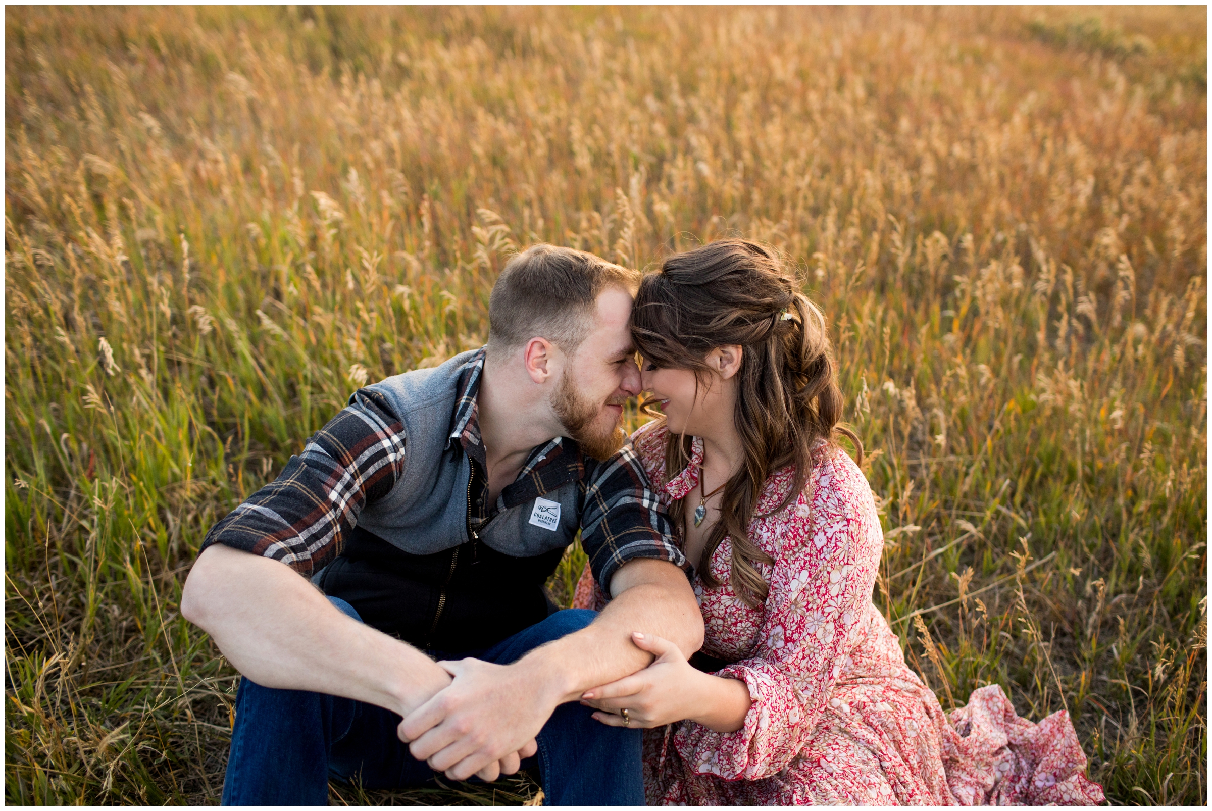 couple sitting in golden field during Summit County Colorado engagement pictures by Plum Pretty Photo 