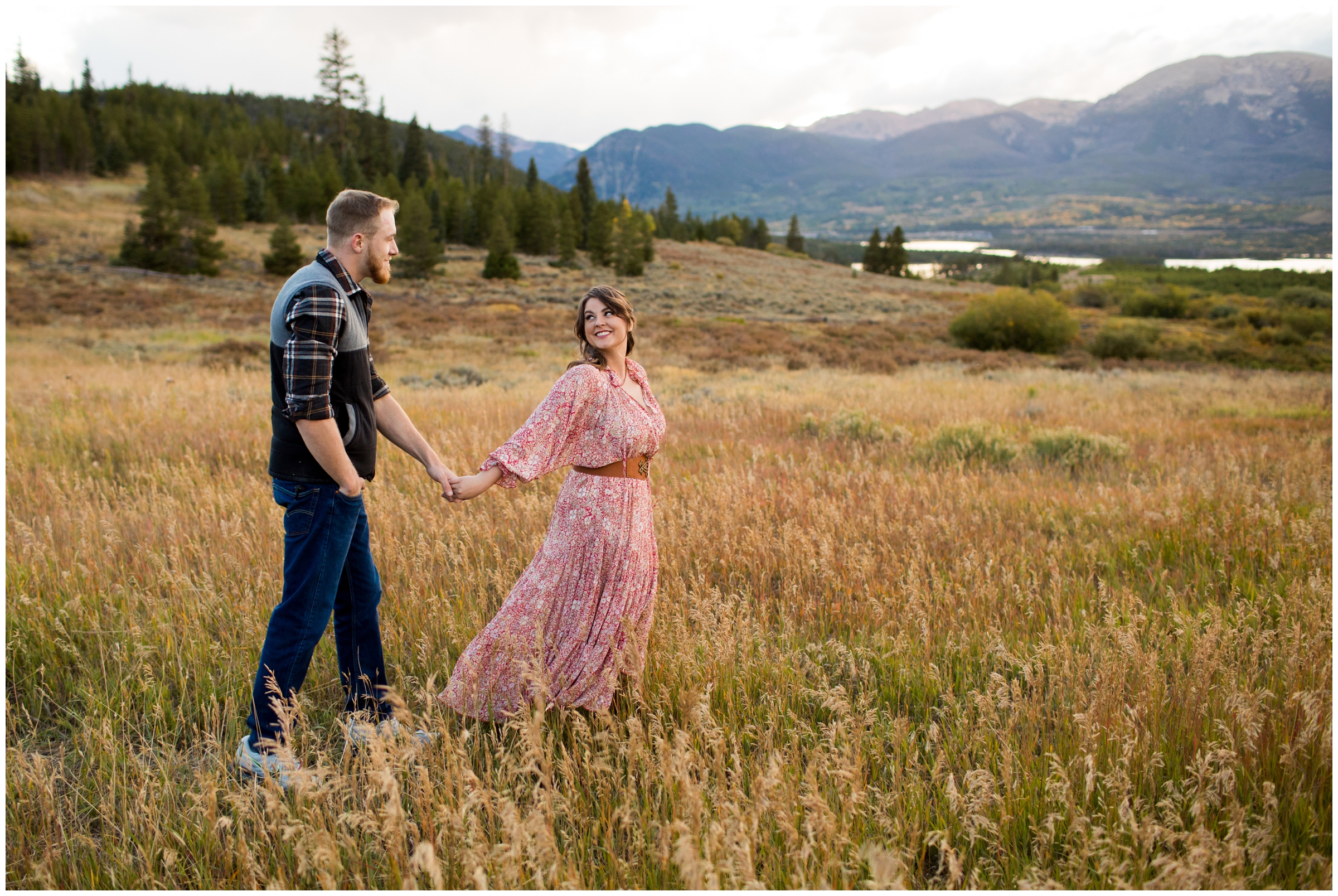 couple walking through field at Windy Point Campground during Colorado mountain engagement pictures 