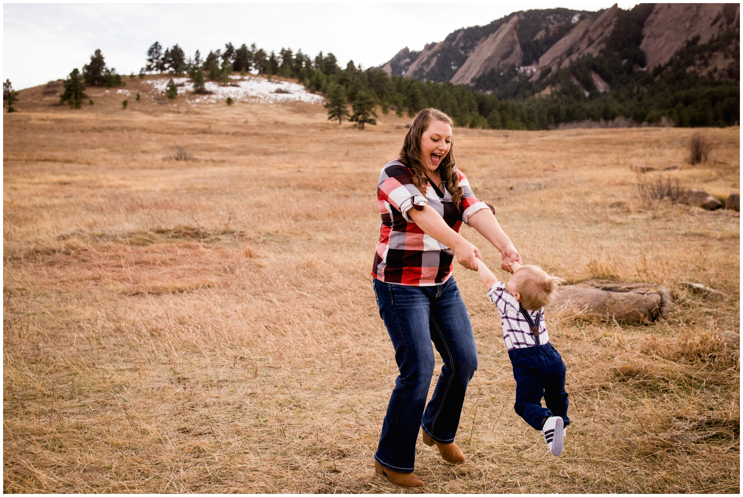 mom spinning son during Boulder family photography session at Chautauqua Park 