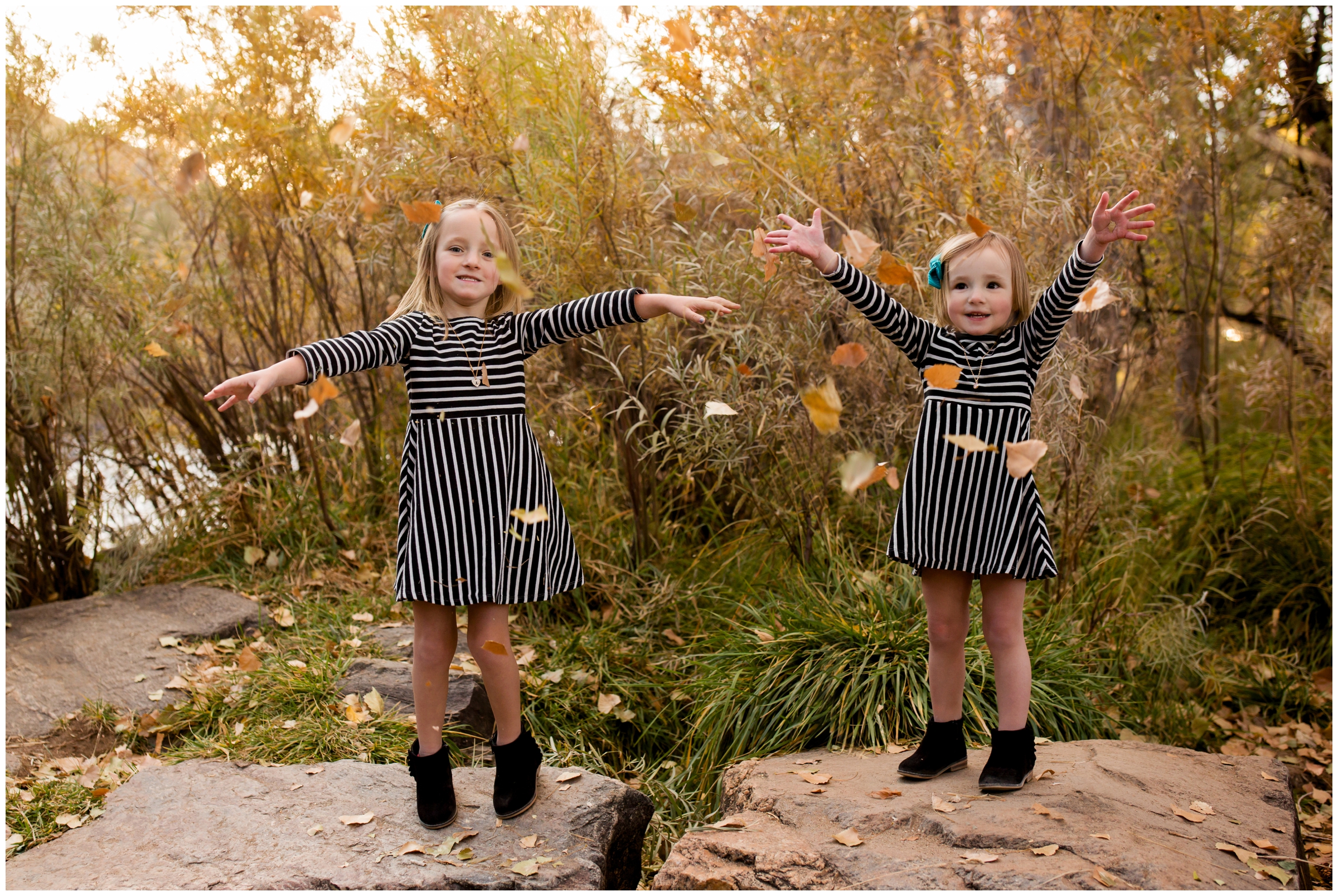 little girls throwing leaves during Golden Colorado fall family photography session 