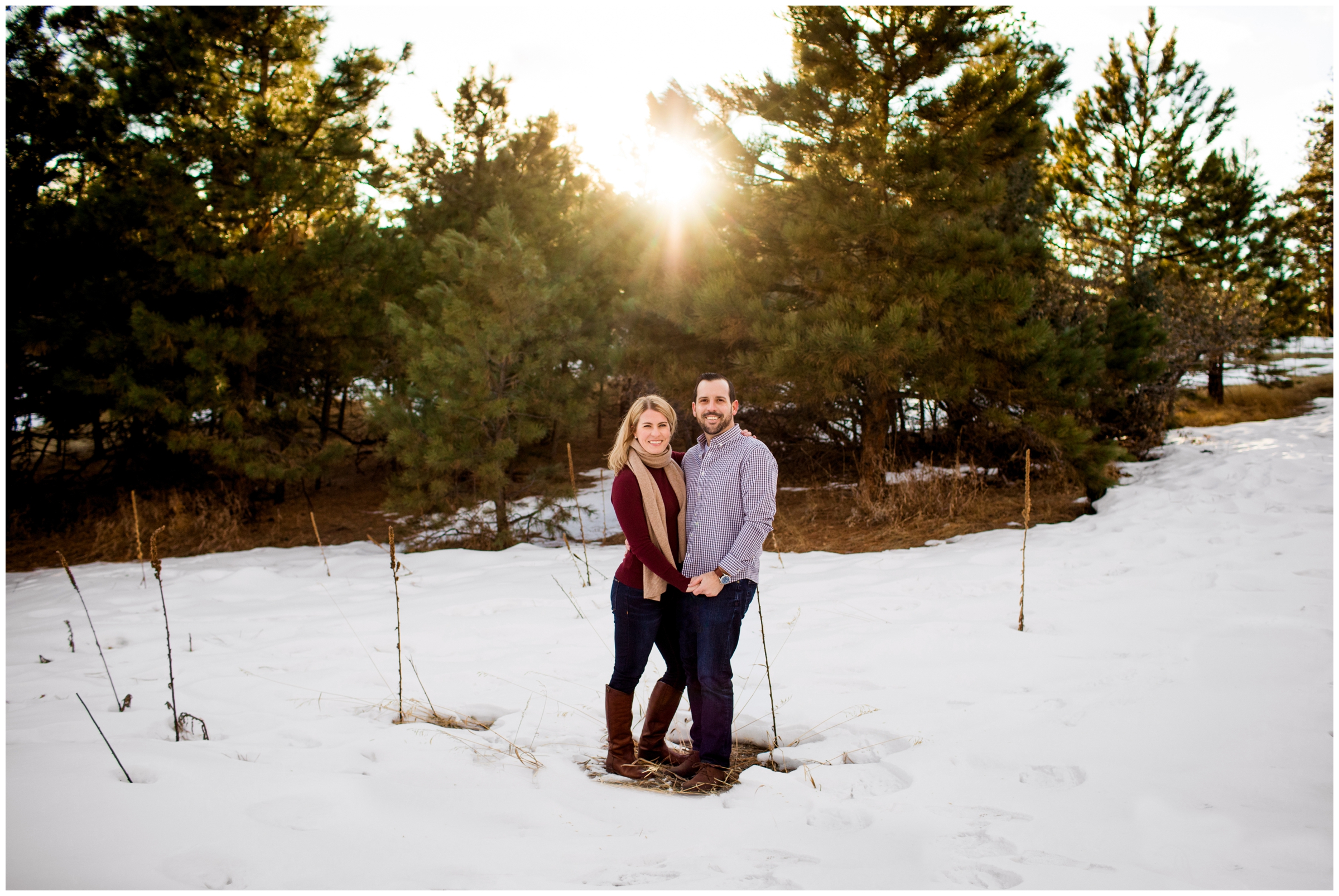 couple posing in the snow during Mt. Falcon Colorado engagement photos 