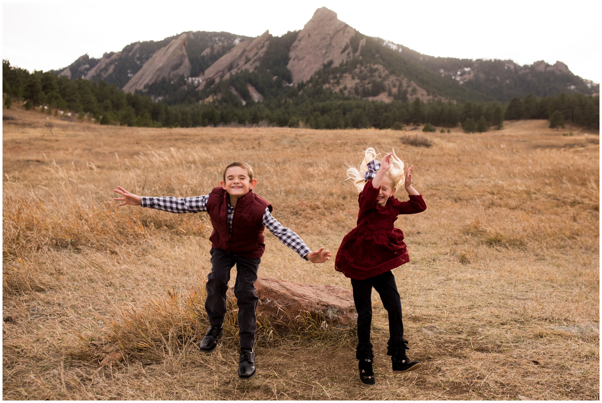 kids jumping off rock during Boulder Colorado fall family portraits 