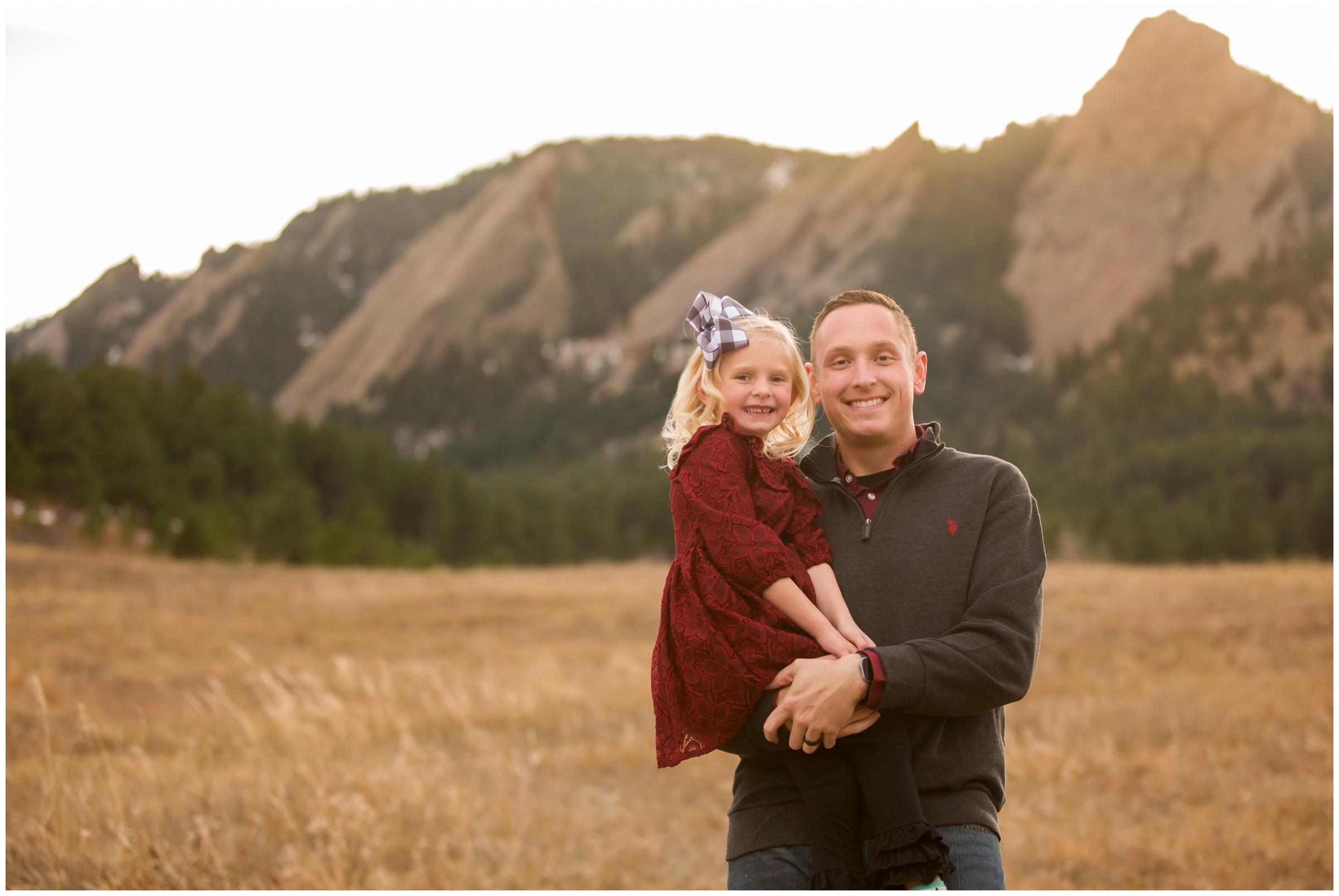 dad holding daughter during fall family photography session in Boulder Colorado 