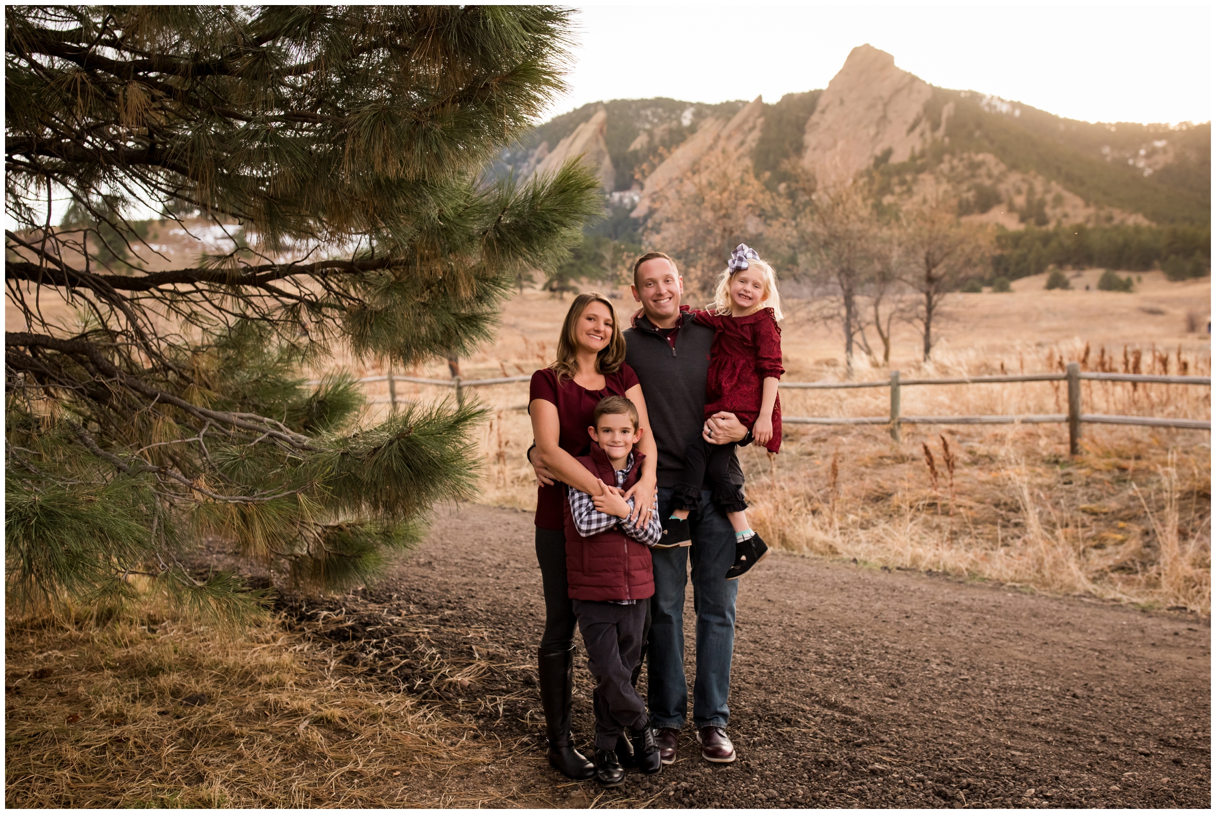 family posing with flatirons in background during Boulder fall portraits 
