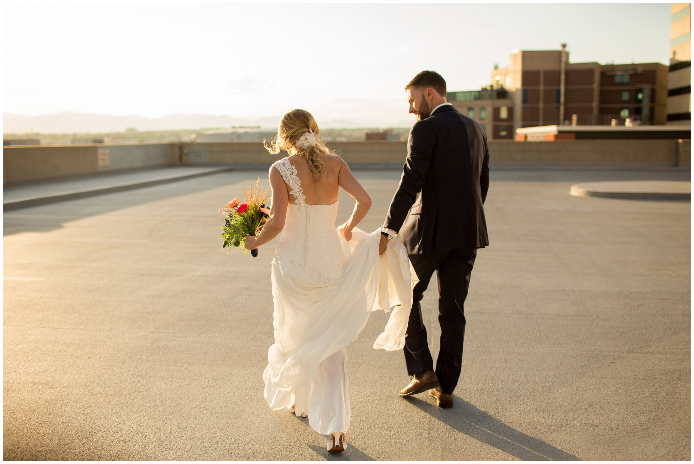 couple walking on rooftop at urban Denver wedding pictures 