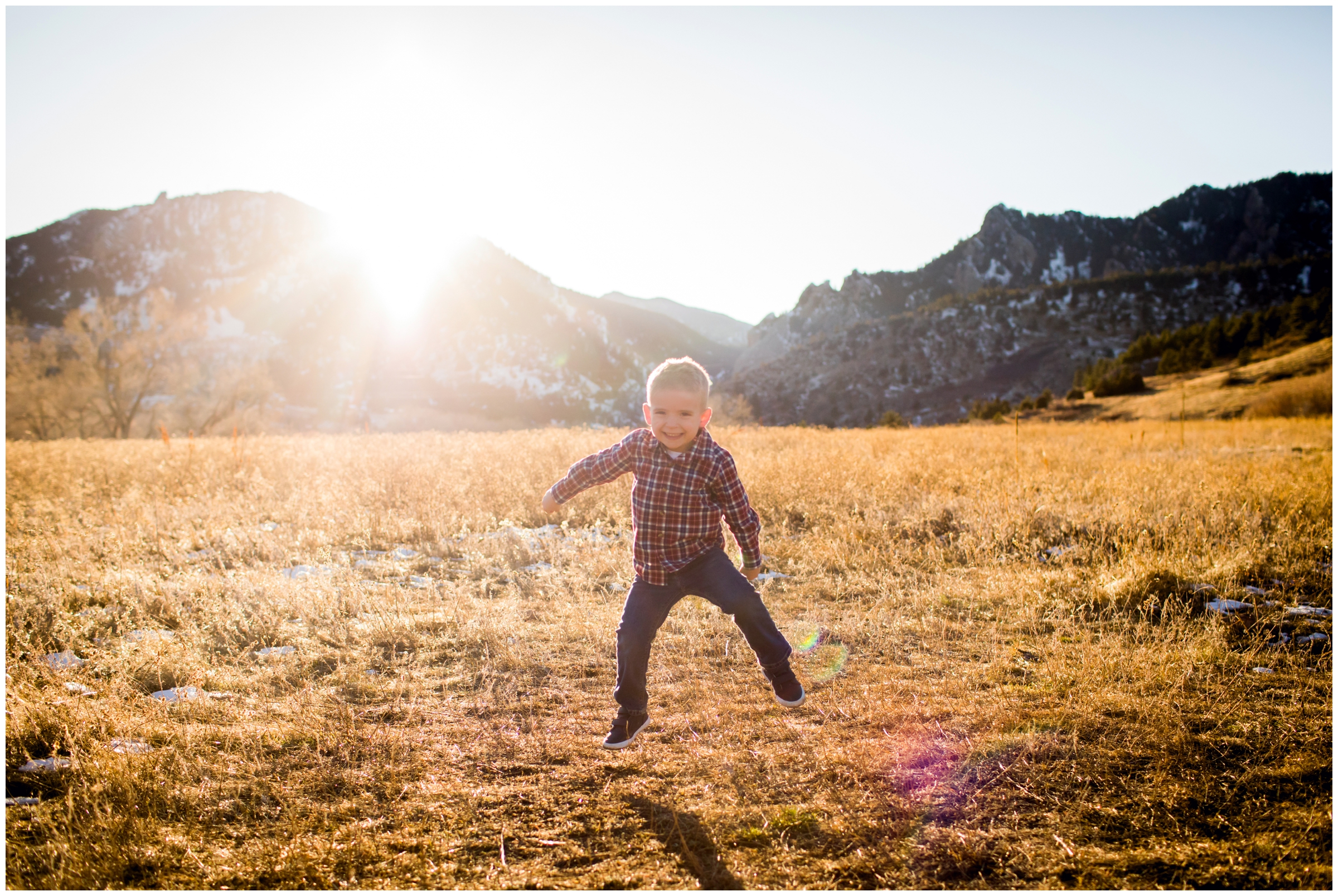 little boy jumping in a field during Colorado fall family pictures 