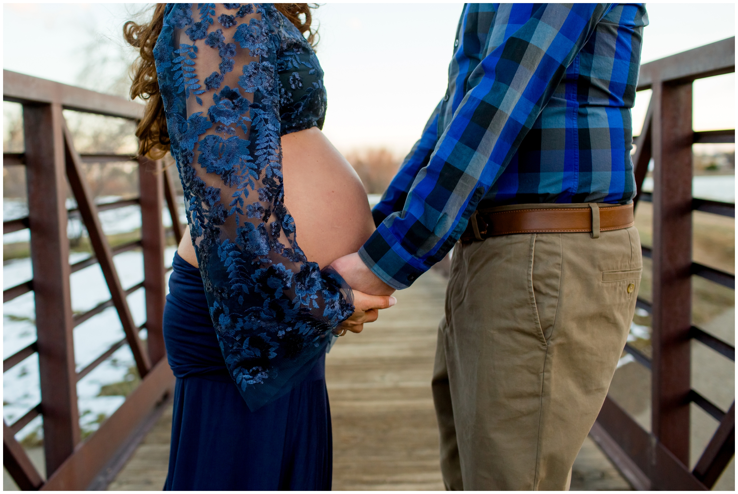 couple posing on bridge during Boulder Colorado maternity portraits 